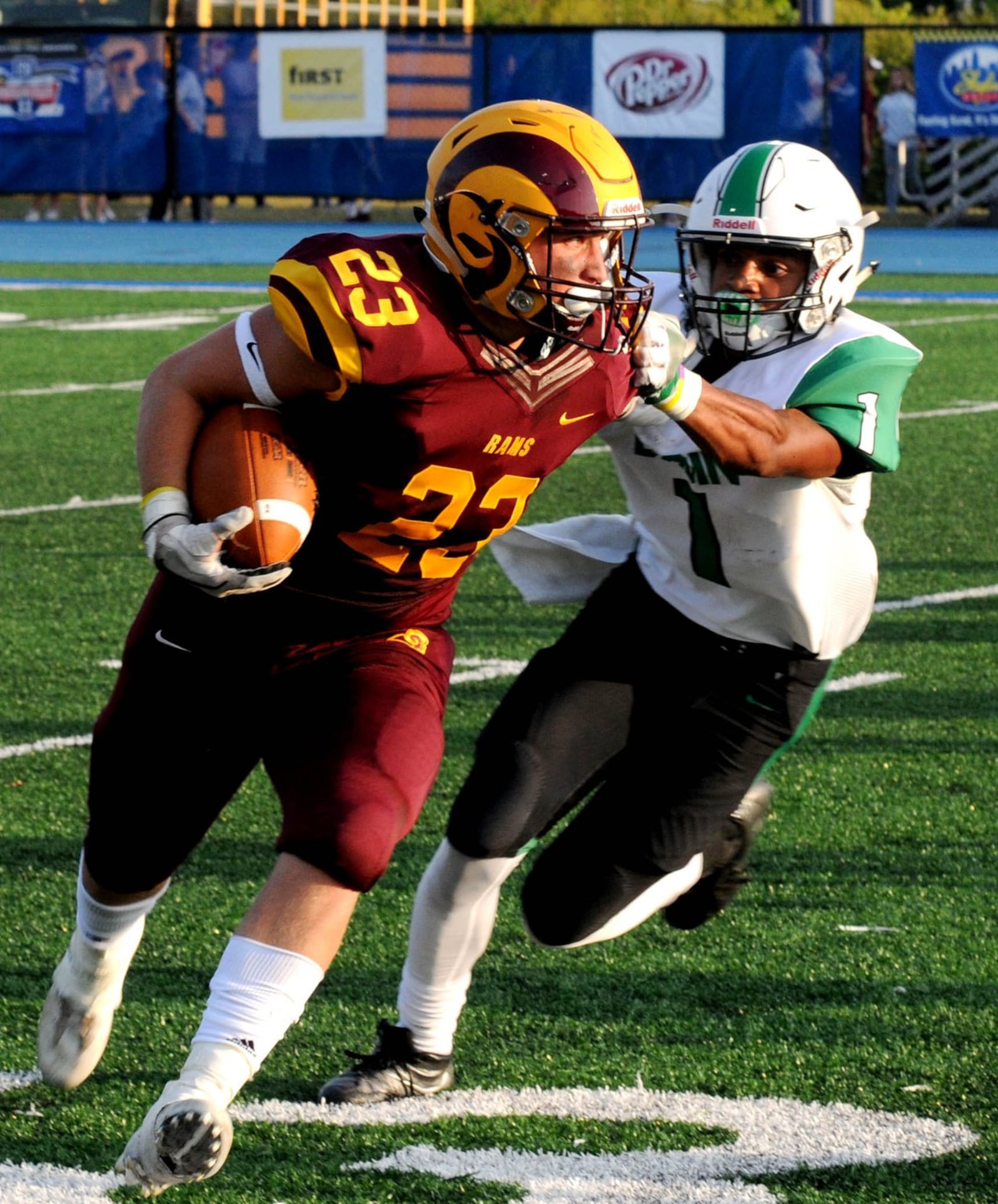 Ethan Mills (23) of Ross tries to elude Badin’s Davon Starks (1) on Friday night at Hamilton’s Virgil Schwarm Stadium. Badin recorded a 36-6 victory in the Skyline Chili Crosstown Showdown contest. CONTRIBUTED PHOTO BY DAVID A. MOODIE