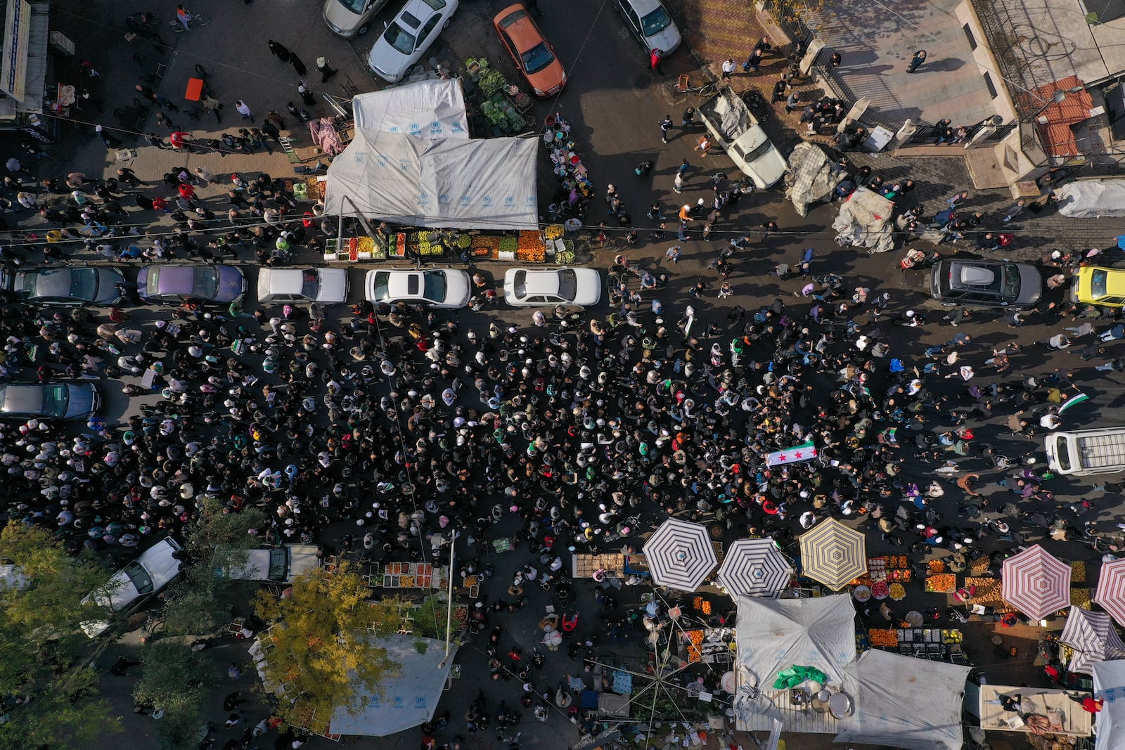 The coffin of Syrian activist Mazen al-Hamada is carried for burial in Damascus Thursday Dec. 12, 2024. Al-Hamad's mangled corpse was found wrapped in a bloody sheet in Saydnaya prison. He had fled to Europe but returned to Syria in 2020 and was imprisoned upon arrival. (AP Photo/Ghaith Alsayed)