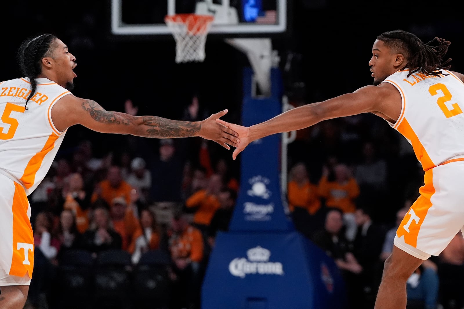 Tennessee guards Zakai Zeigler (5), left, and Chaz Lanier (2), right, high five during the first half of an NCAA college basketball game against Miami, Tuesday, Dec. 10, 2024, in New York. (AP Photo/Julia Demaree Nikhinson)