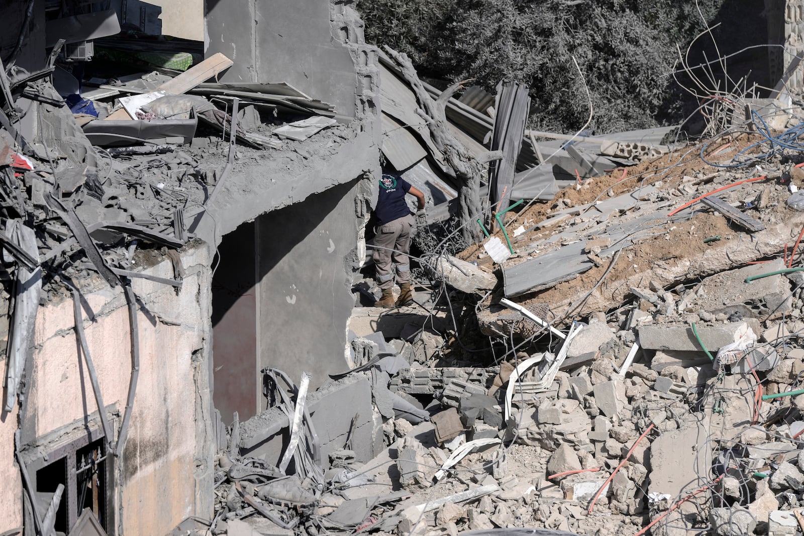 A civil defence worker searches for victims in the rubble of a destroyed building hit in an Israeli airstrike on Tuesday night, in Sarafand, southern Lebanon, Wednesday, Oct. 30, 2024. (AP Photo/Bilal Hussein)