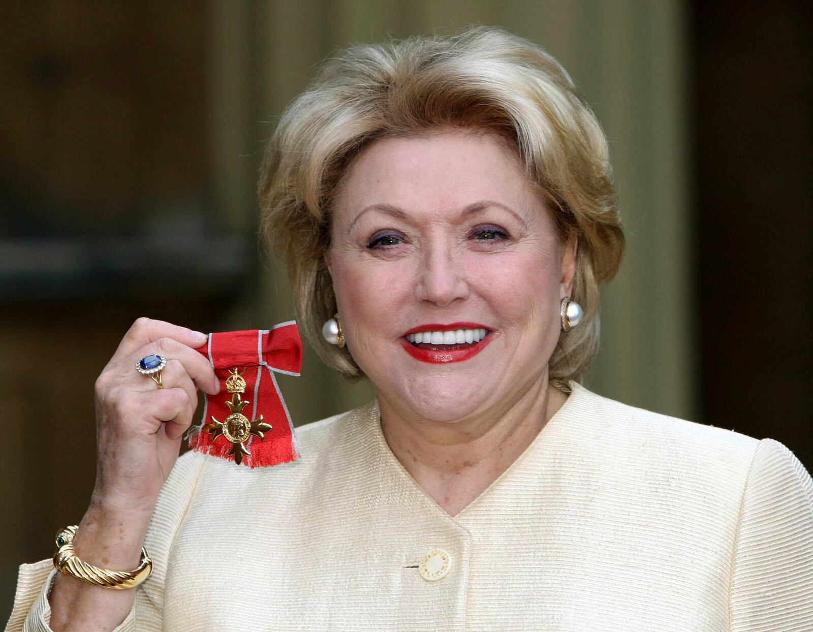 FILE - Author Barbara Taylor Bradford after she received her Most Excellent Order of the British Empire from Britain's Queen Elizabeth II at Buckingham Palace, London, Wednesday, Oct. 10, 2007. (Steve Parsons/Pool Photo via AP, File)