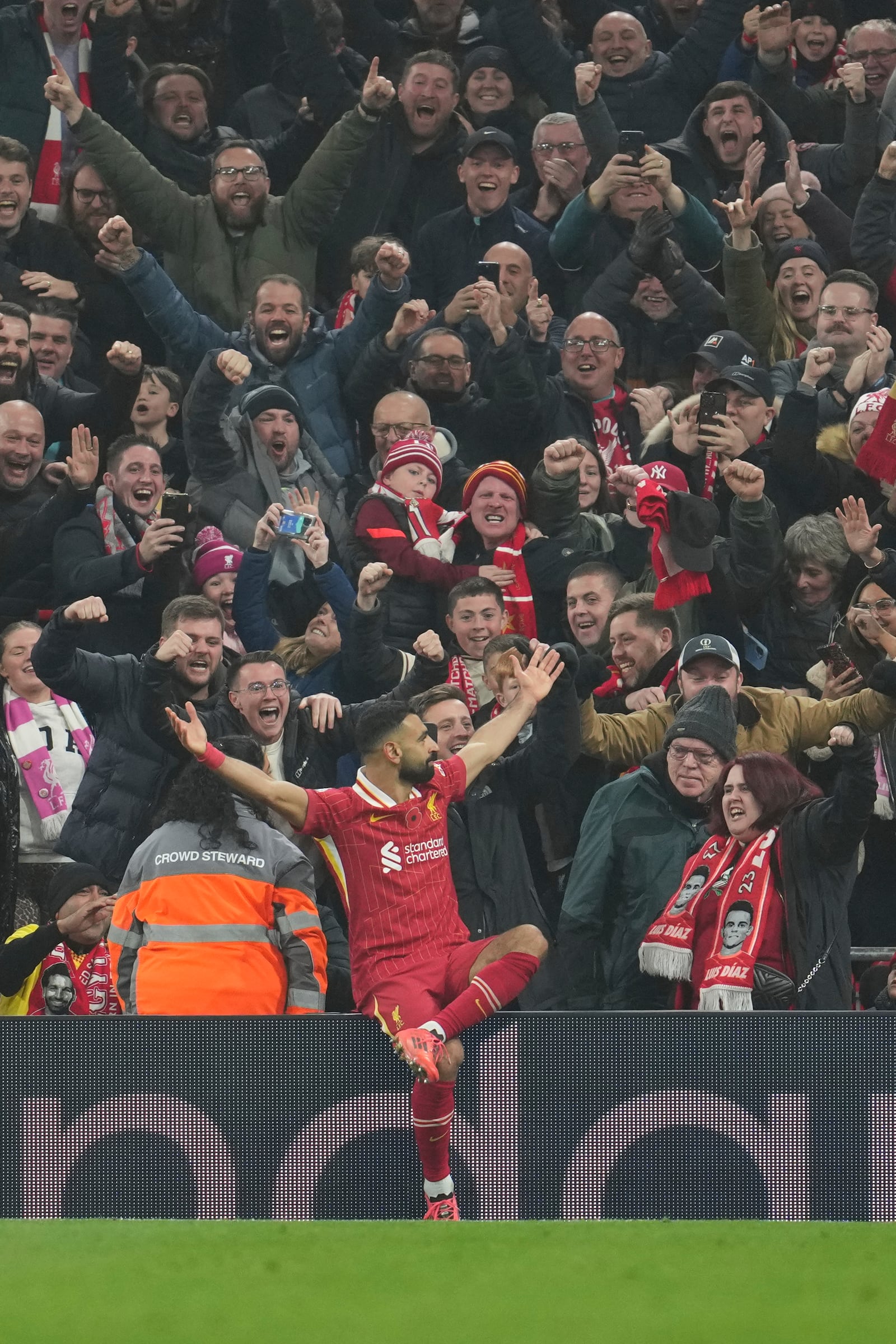 Liverpool's Mohamed Salah celebrates after scoring his side's 2nd goal against Aston Villa during the English Premier League soccer match at the Anfield stadium in Liverpool, Saturday, Nov. 9, 2024. (AP Photo/Jon Super)