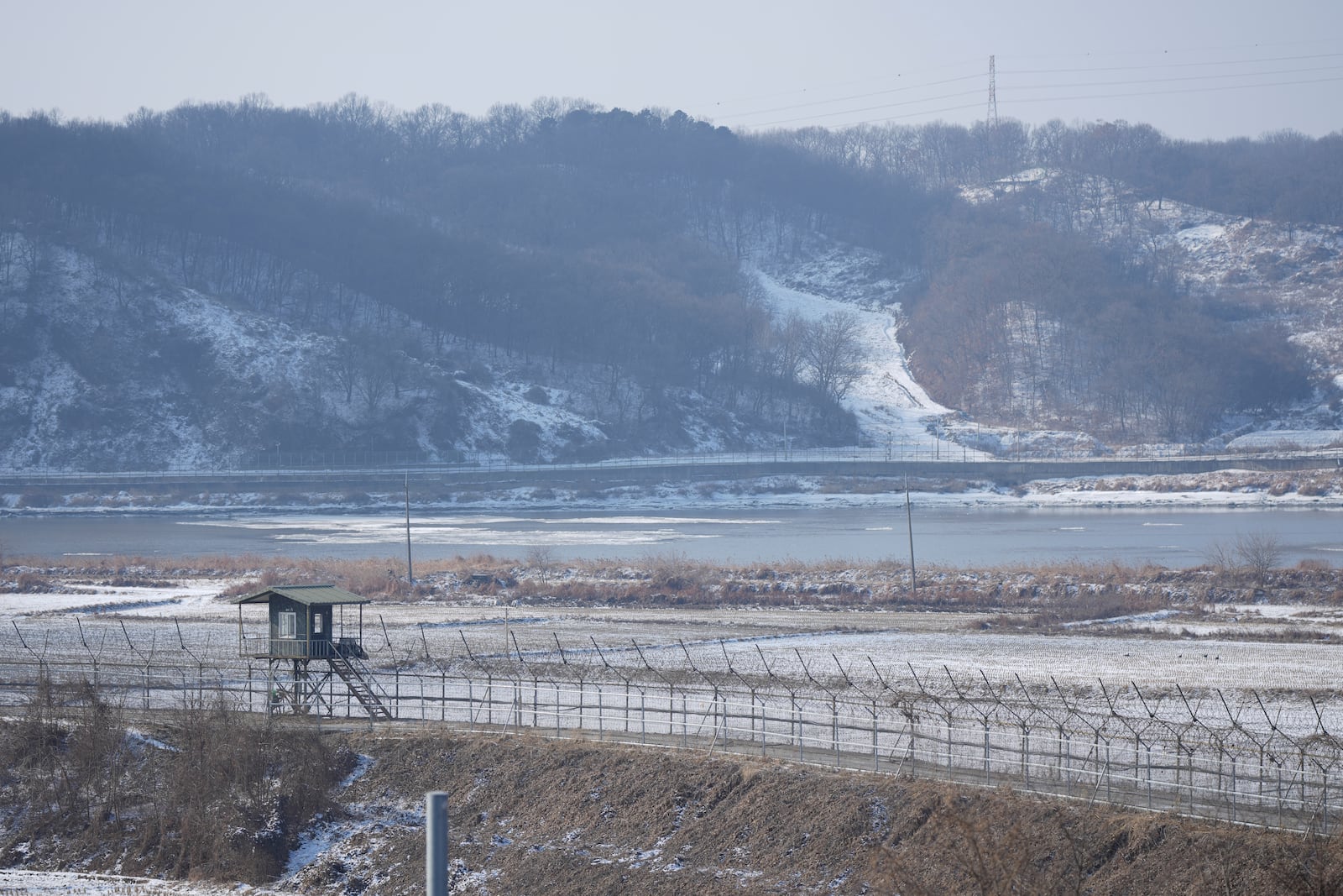 South Korean military's barbed-wire fence is seen near the snow covered field in Paju, South Korea, Wednesday, Jan. 29, 2025. (AP Photo/Lee Jin-man)