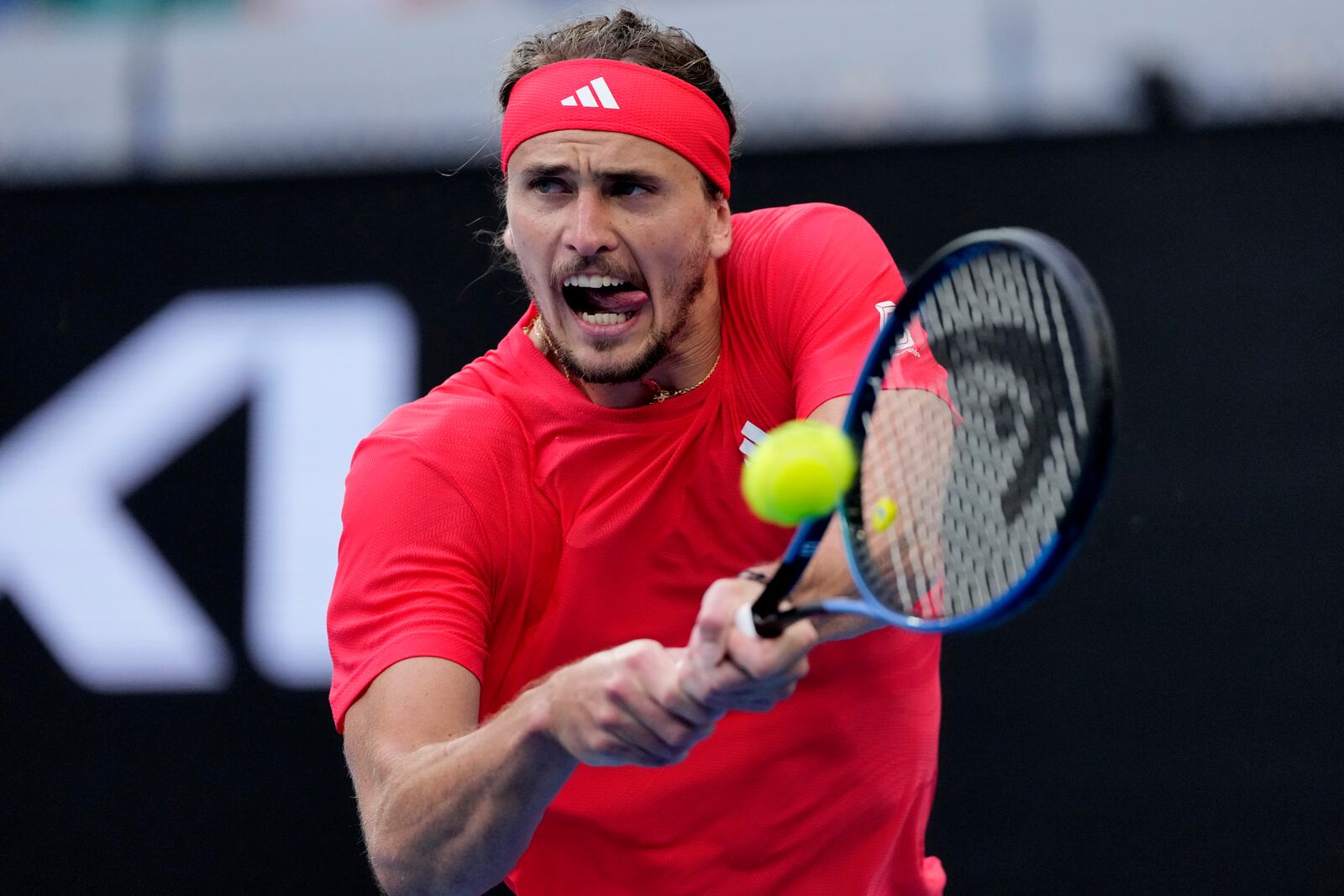 Alexander Zverev of Germany makes a backhand return to Ugo Humbert of France during their fourth round match at the Australian Open tennis championship in Melbourne, Australia, Sunday, Jan. 19, 2025. (AP Photo/Vincent Thian)