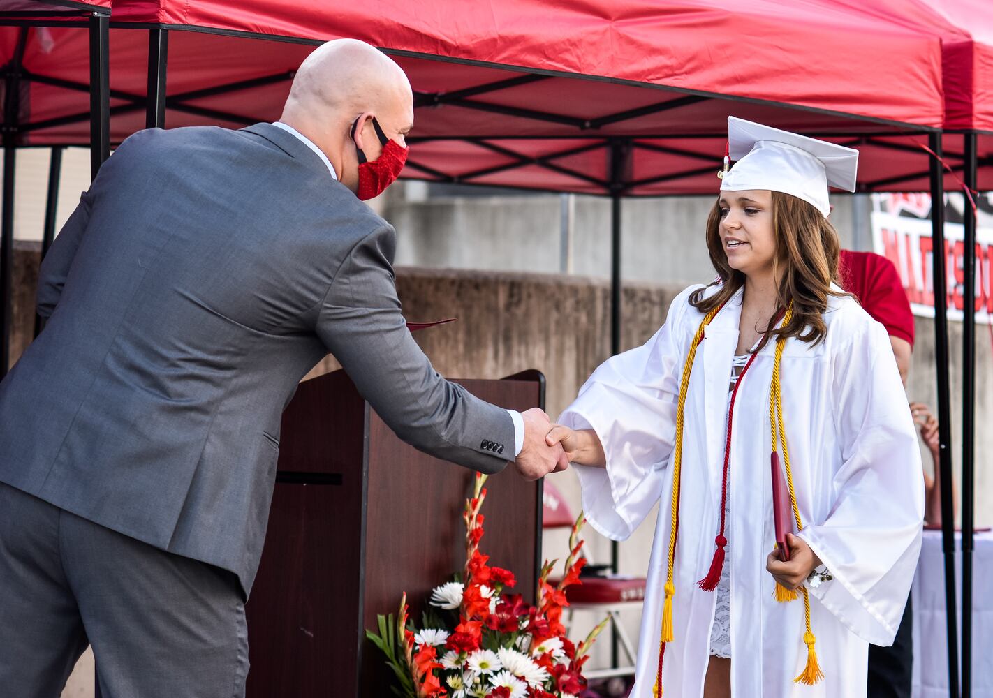 Madison High School drive-thru graduation ceremony at Land of Illusion