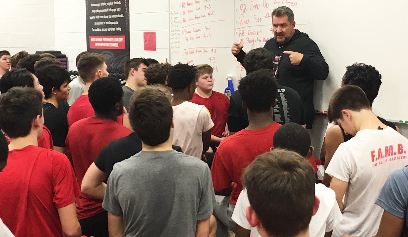 New Lakota West High School football coach Tom Bolden talks to his team during a workout session at the school Thursday afternoon. RICK CASSANO/STAFF