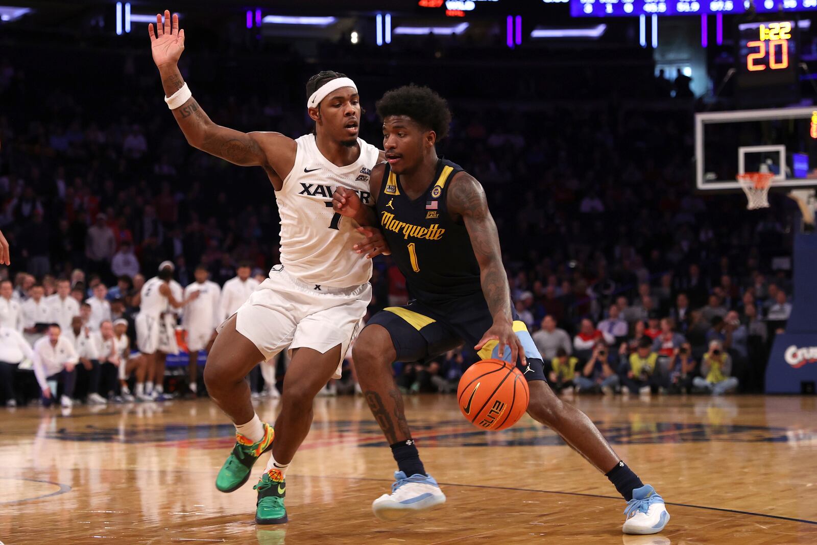 Marquette guard Kam Jones (1) dribbles against Xavier guard Ryan Conwell (7) during the second half of an NCAA college basketball game in the quarterfinals of the Big East Conference tournament, Thursday, March 13, 2025, in New York. (AP Photo/Pamela Smith)