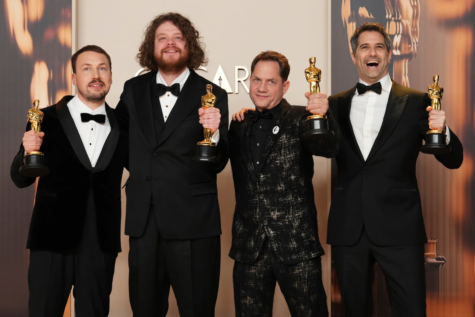 From left, Gints Zilbalodis, Matiss Kaza, Ron Dyens and Gregory Zalcman, winners of the award for best animated feature film for "Flow," pose in the press room at the Oscars on Sunday, March 2, 2025, at the Dolby Theatre in Los Angeles. (Photo by Jordan Strauss/Invision/AP)