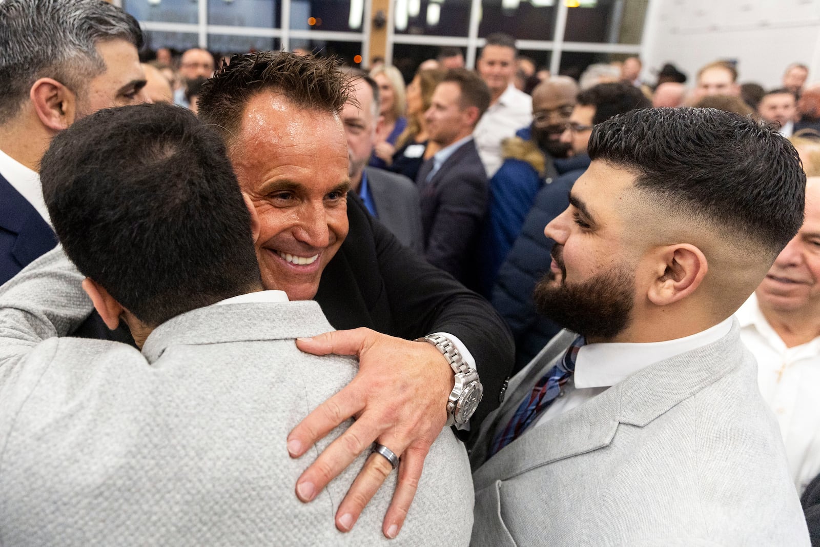 Genesee County Sheriff Chris Swanson is embraced as he announces his campaign to run for governor of Michigan in the 2026 election Thursday, Feb. 6, 2025, at Mott Community College in Flint, Mich. (Jake May/The Flint Journal via AP)