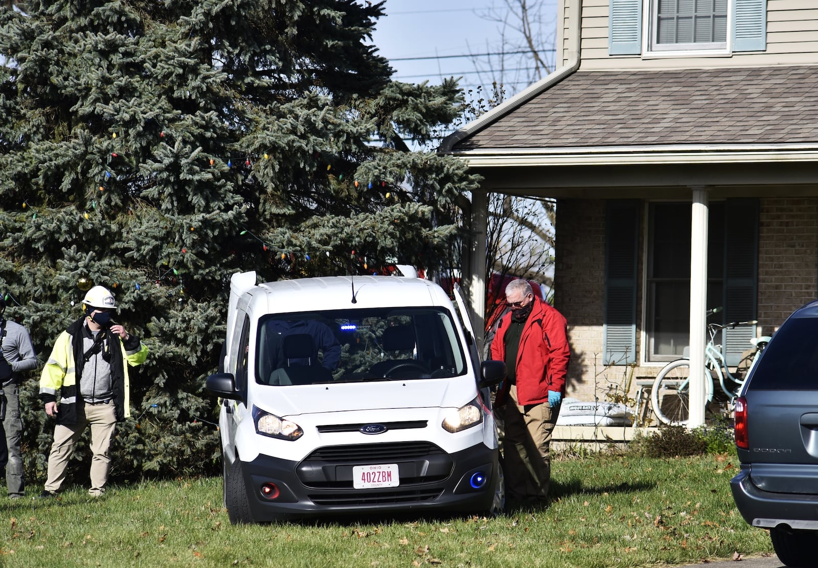 Emergency units work to remove a truck that slammed into a Monroe house this morning NICK GRAHAM/STAFF