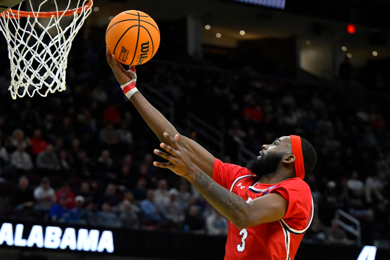 Robert Morris guard Amarion Dickerson (3) drives to the basket against Alabama in the first half in the first round of the NCAA college basketball tournament, Friday, March 21, 2025, in Cleveland. (AP Photo/David Richard)