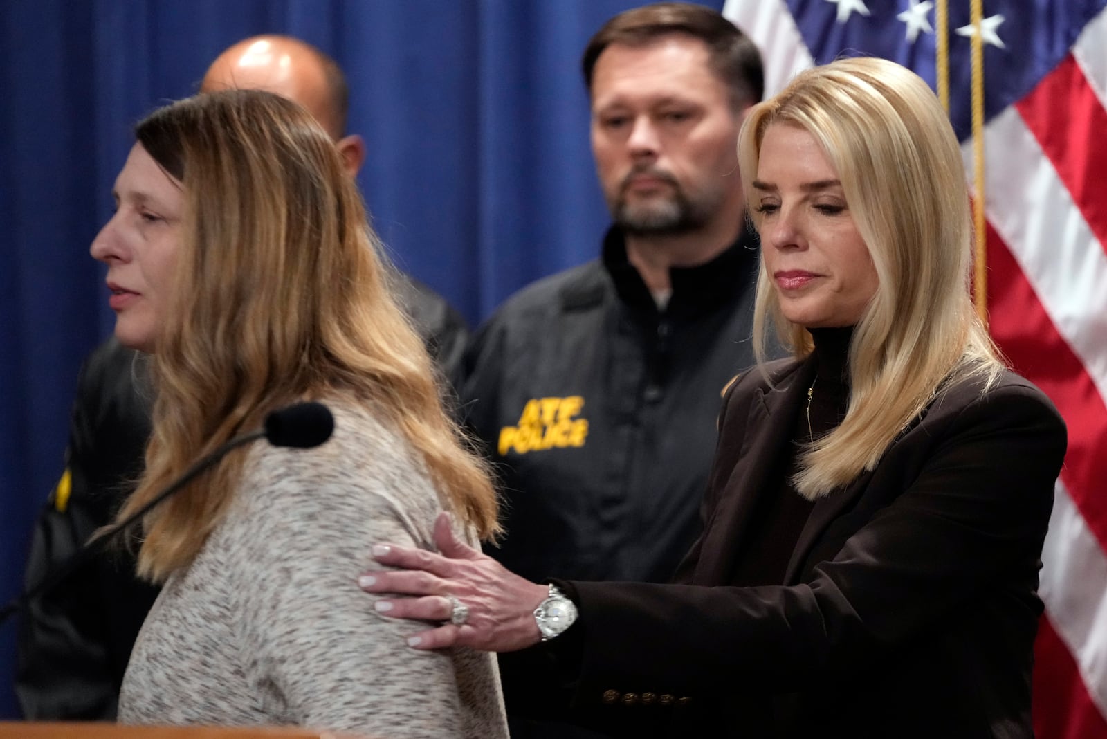 Attorney General Pam Bondi comforts Tammy Nobles, mother of Kayla Hamilton, after speaking at a news conference regarding immigration enforcement at the Justice Department, Wednesday, Feb. 12, 2025, in Washington. (AP Photo/Ben Curtis)