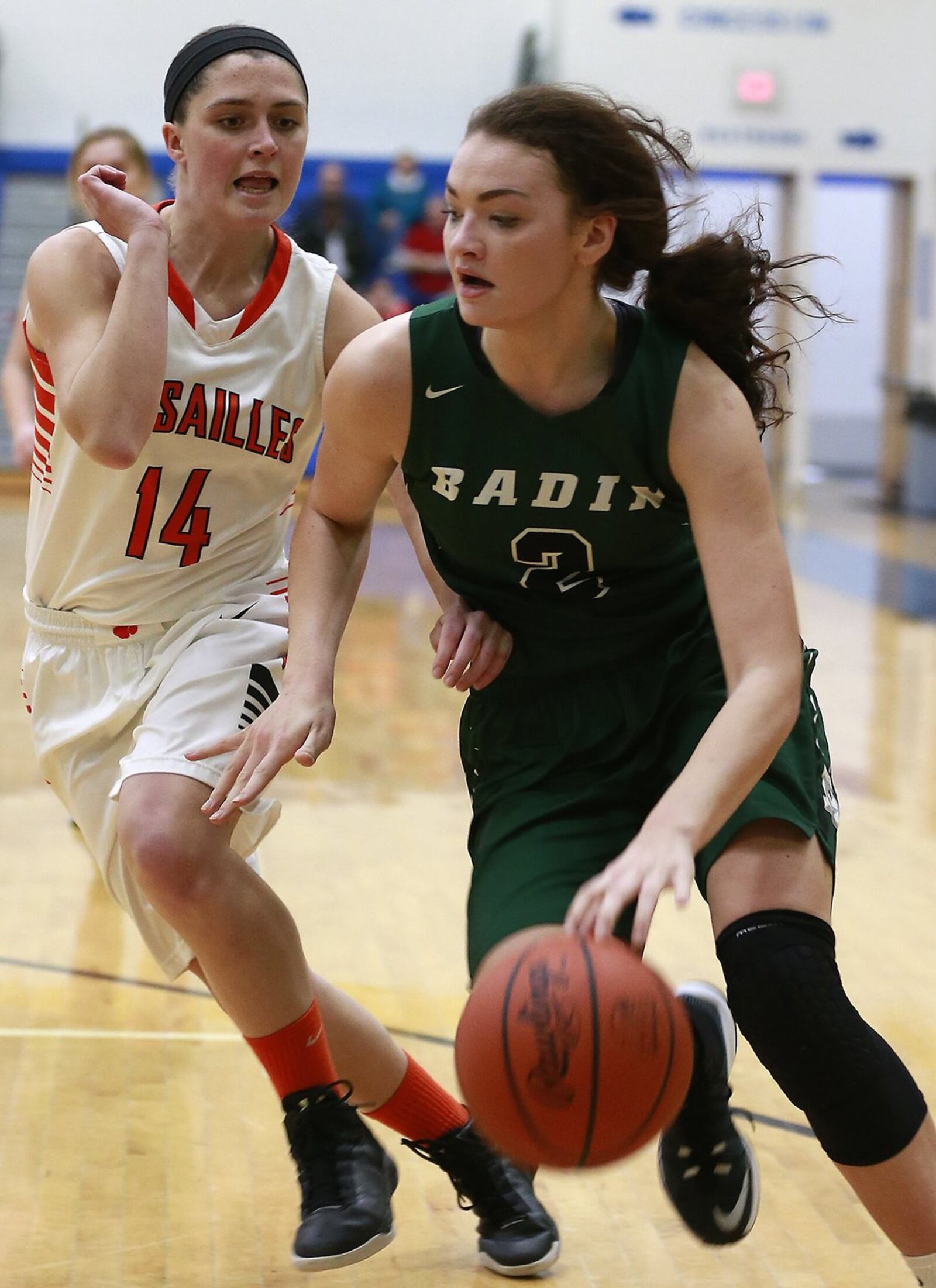 Badin’s Shelby Nusbaum surges past Versailles’ Brynna Blakeley during Wednesday night’s Division III regional semifinal at Springfield. BILL LACKEY/STAFF