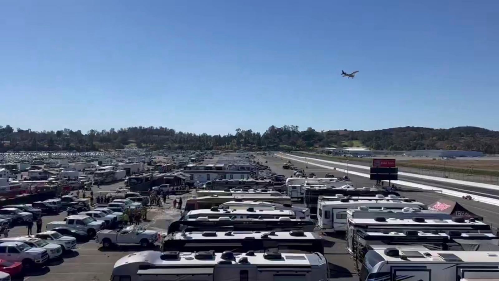 This image taken from video provided by Jerry Jordan shows the fire department and others working at the site of a single-engine plane crash Sunday, Nov. 17, 2024, near a Southern California racing event, in Pomona, Calif., about 30 miles (50 kilometers) east of downtown Los Angeles. (Jerry Jordan via AP)