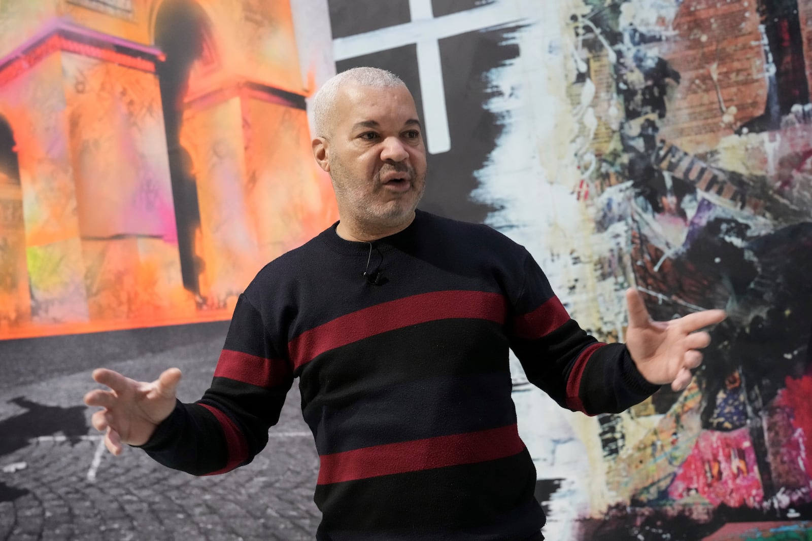 French street artist Shuck One gestures during an interview with AP during the preparation of the exhibition "Paris Noir", at the Centre Pompidou Museum, in Paris, Tuesday, Feb. 18, 2025. (AP Photo/Thibault Camus)