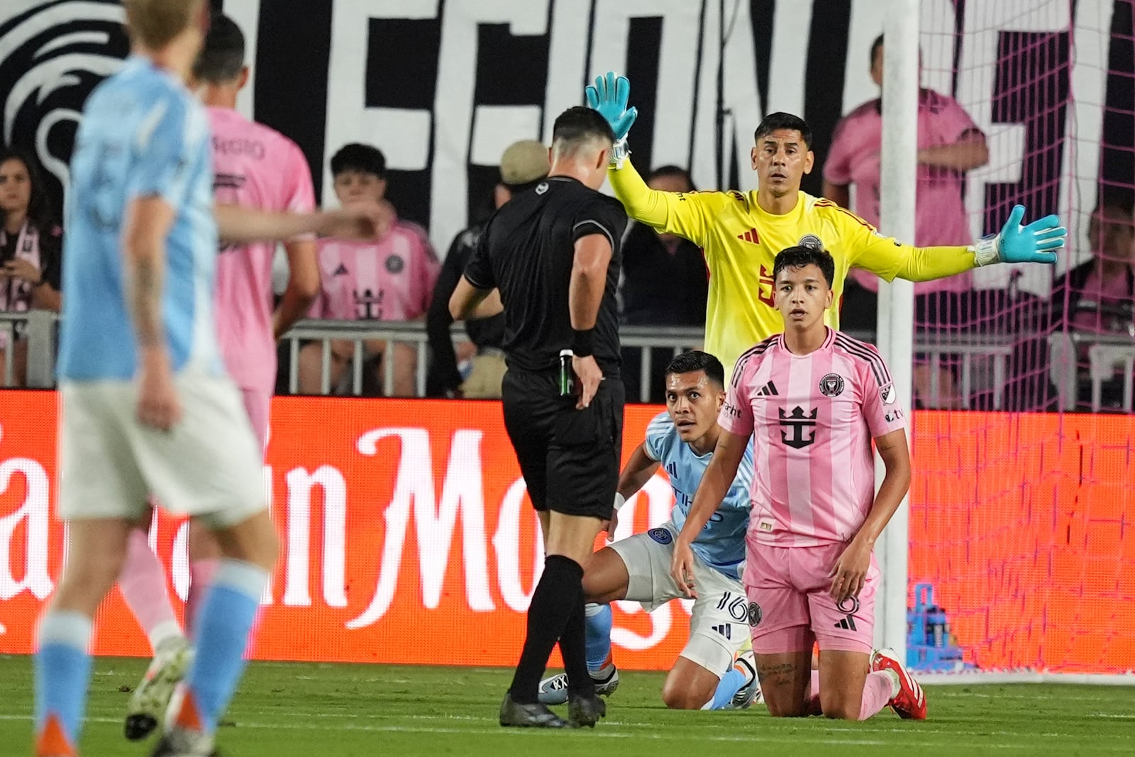 A referee pulls out a red card for Inter Miami midfielder Tomas Aviles (6) as New York City FC forward Alonso Martinez (16) and Inter Miami goalkeeper Oscar Ustari (19) look on during the first half of an MLS soccer match, Saturday, Feb. 22, 2025, in Fort Lauderdale, Fla. (AP Photo/Rebecca Blackwell)