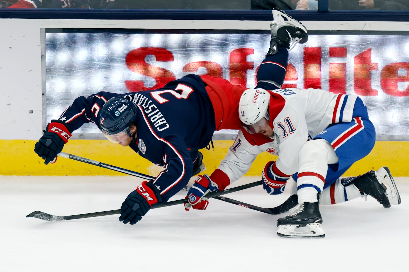 Columbus Blue Jackets defenseman Jake Christiansen, left, collides with Montreal Canadiens forward Brendan Gallagher during the third period of an NHL hockey game in Columbus, Ohio, Wednesday, Nov. 27, 2024. The Canadiens won 4-3 in overtime. (AP Photo/Paul Vernon)