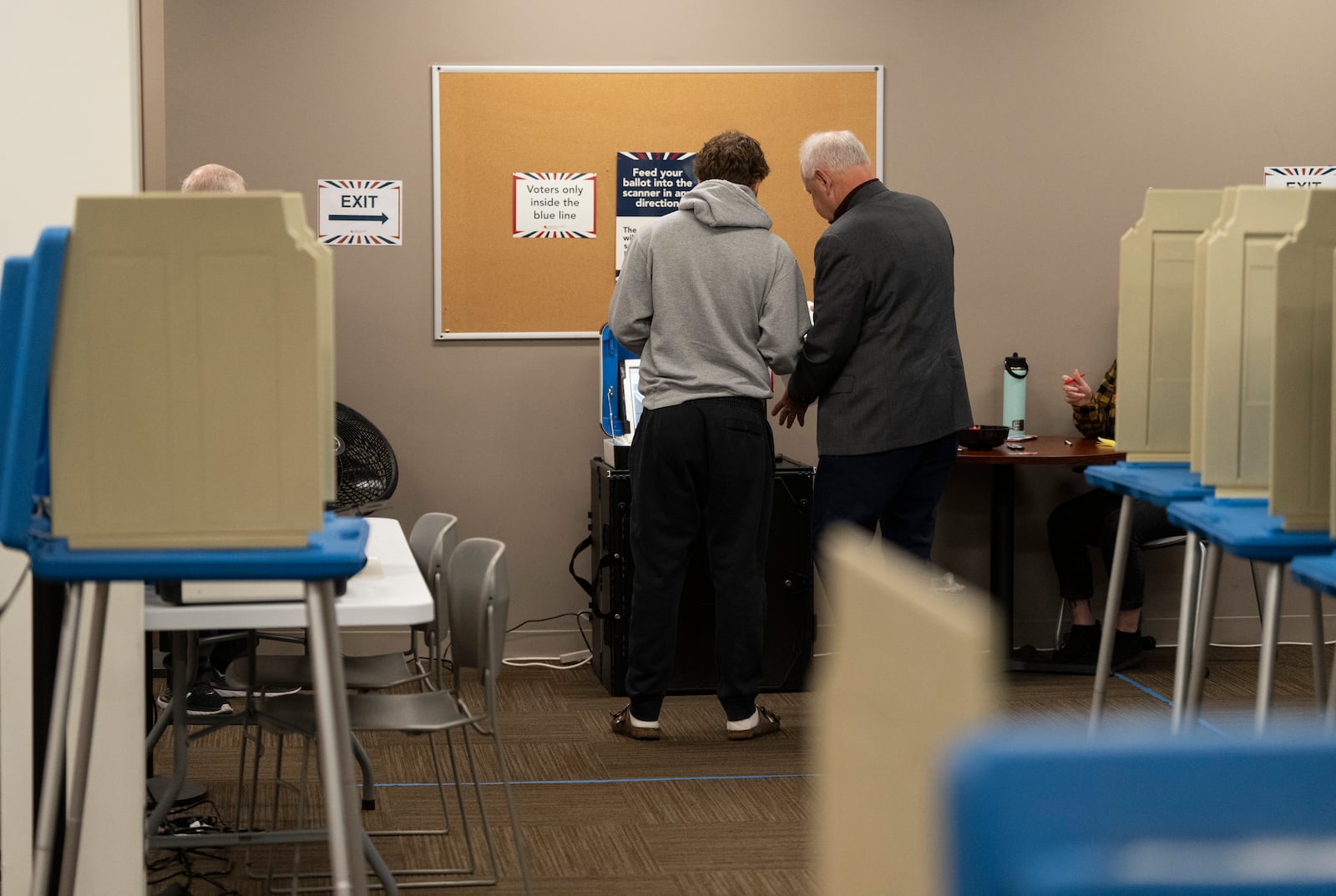 Minnesota Governor and Vice Presidential candidate Tim Walz, right, and his son, Gus Walz, a first time voter, cast their ballots during early voting at Ramsey County Elections in St. Paul, Minn., on Wednesday, October 23, 2024. (Renée Jones Schneider/Star Tribune via AP)