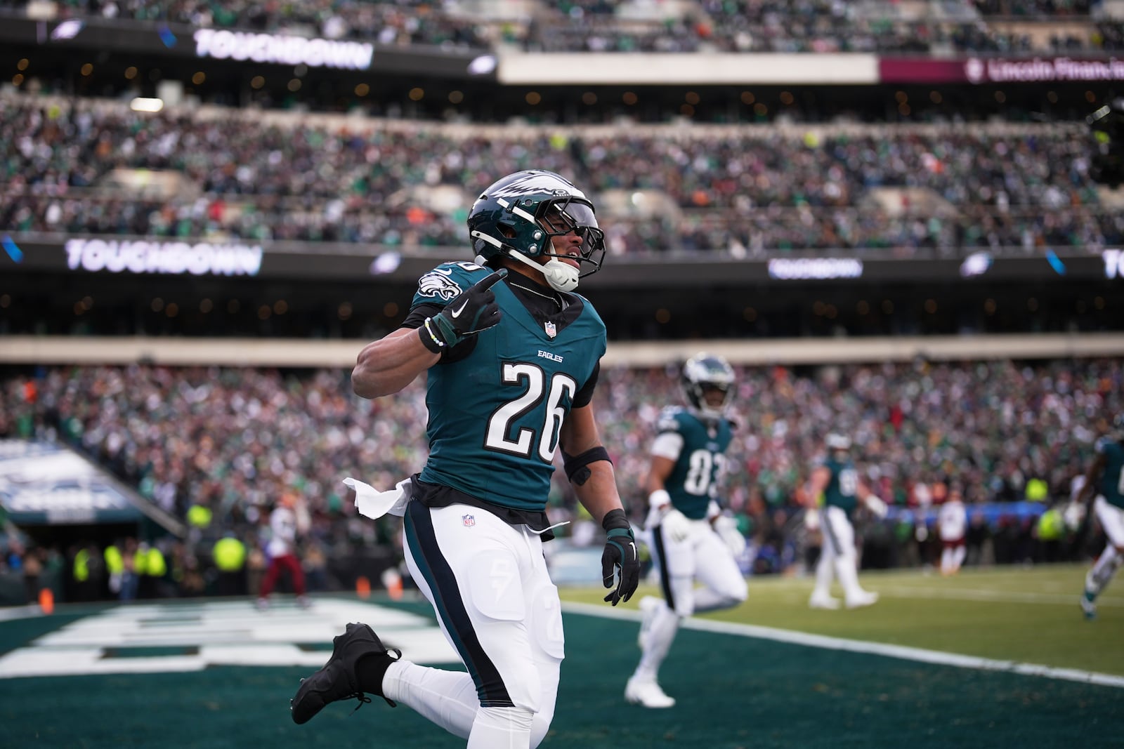 Philadelphia Eagles running back Saquon Barkley (26) celebrates after running for a touchdown against the Washington Commanders during the first half of the NFC Championship NFL football game, Sunday, Jan. 26, 2025, in Philadelphia. (AP Photo/Matt Slocum)