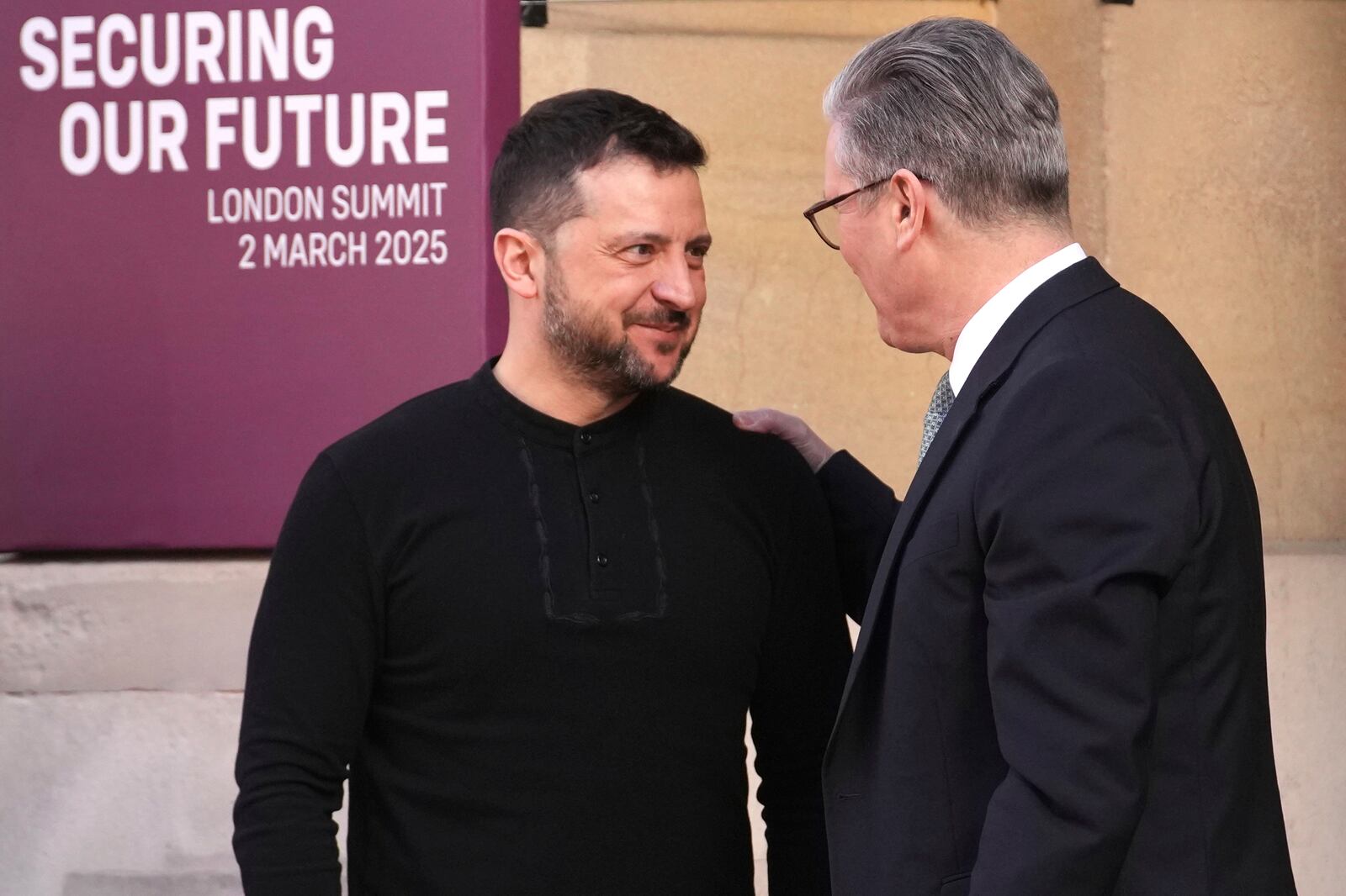 Britain's Prime Minister Keir Starmer, right, greets Ukraine's President Volodymyr Zelenskyy as he arrives for a summit on Ukraine at Lancaster House in London, Sunday, March 2, 2025. (AP Photo/Christophe Ena, Pool)