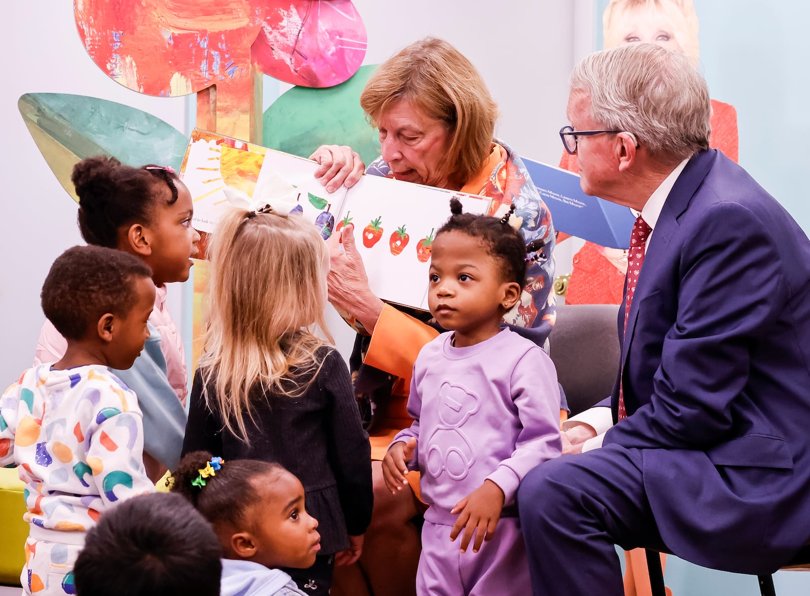 Ohio Gov. Mike DeWine and first lady Fran DeWine visit a Butler County WIC office to read books to kids and promote a new children's reading kiosk Monday, Oct. 28, 2024, in downtown Hamilton. Ten reading kiosks, developed by the Ohio Department of Health and Dolly Parton's Imagination Library, are being installed at WIC offices around the state to be used by families visiting the clinics. NICK GRAHAM/STAFF