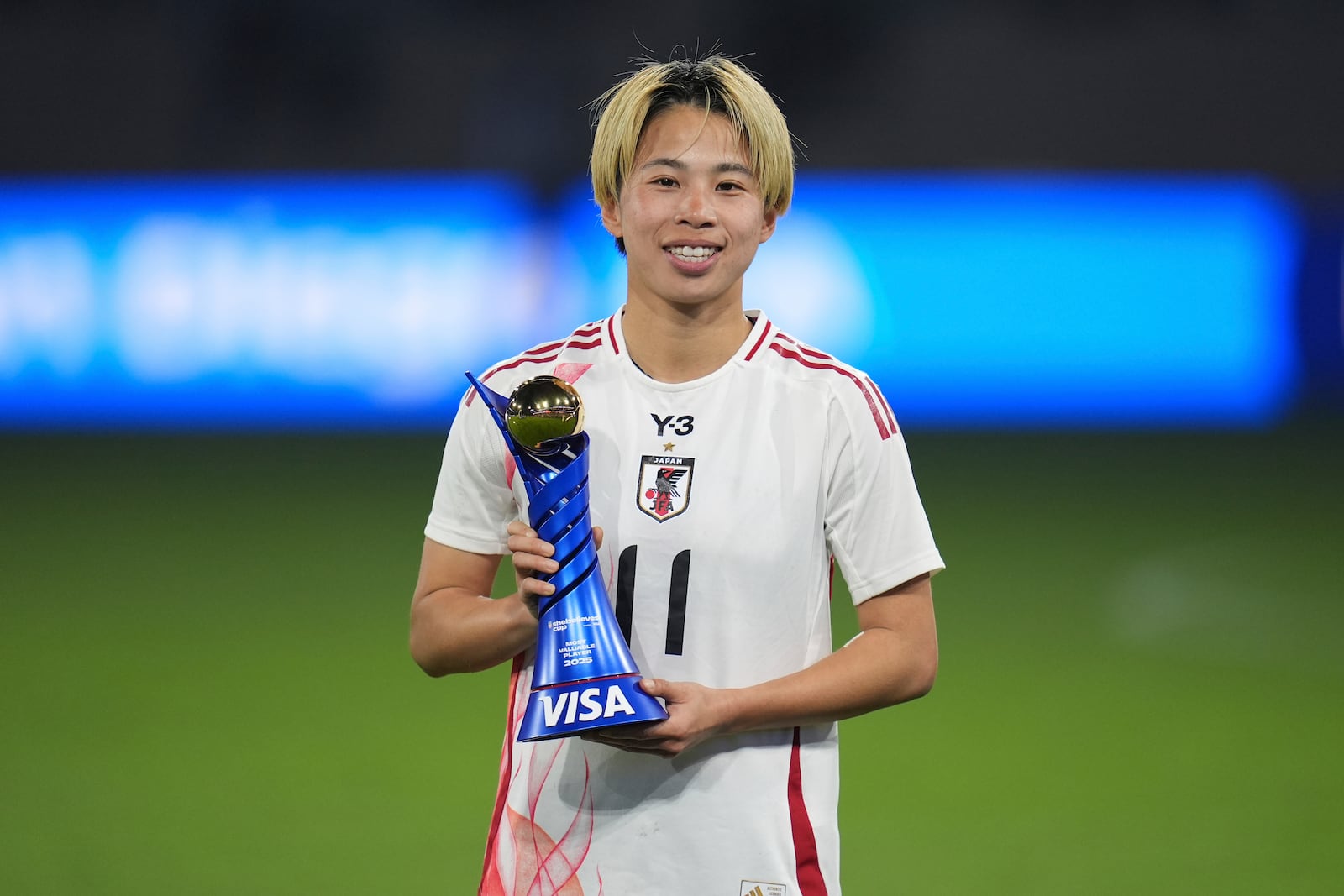 Japan forward Mina Tanaka poses with the Most Valuable Player trophy after Japan defeated the United States to win the SheBelieves Cup women's soccer tournament Wednesday, Feb. 26, 2025, in San Diego. (AP Photo/Gregory Bull)