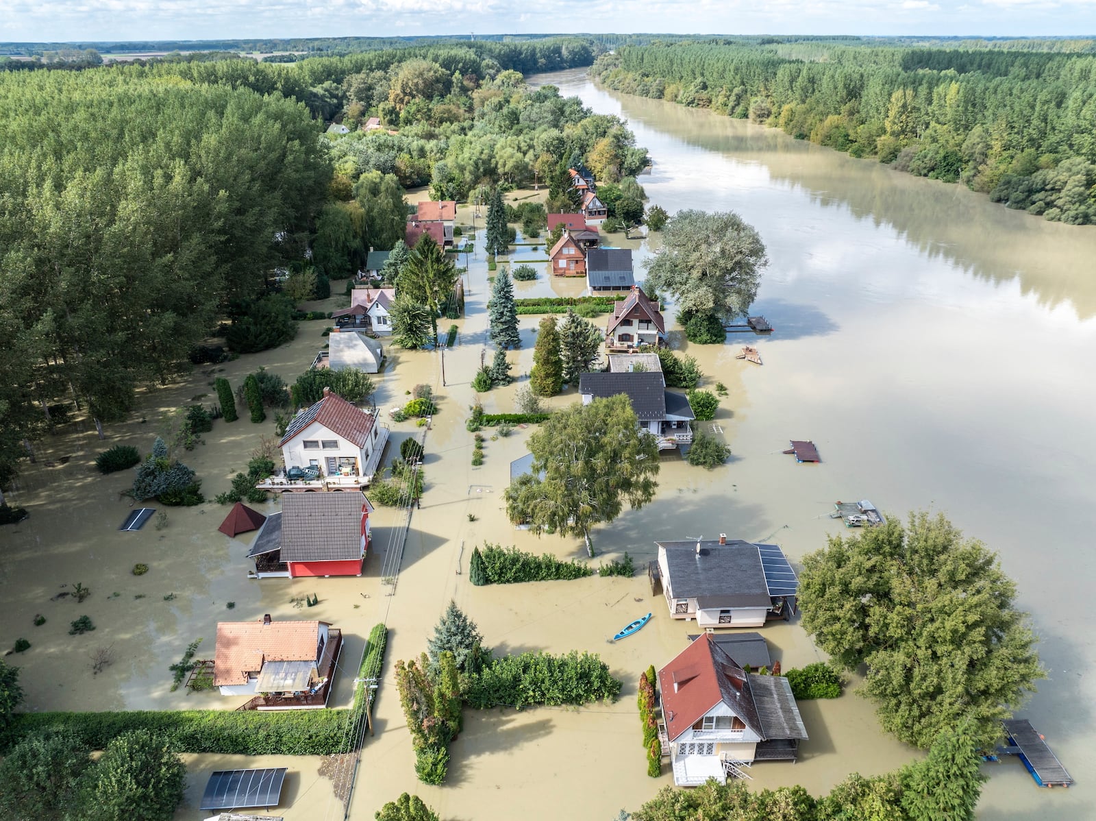 An aerial picture taken with a drone shows the flooded resort village of Venek and the swollen Danube River near Gyor, Hungary, Tuesday, September 17, 2024. (Gergely Janossy/MTI via AP)