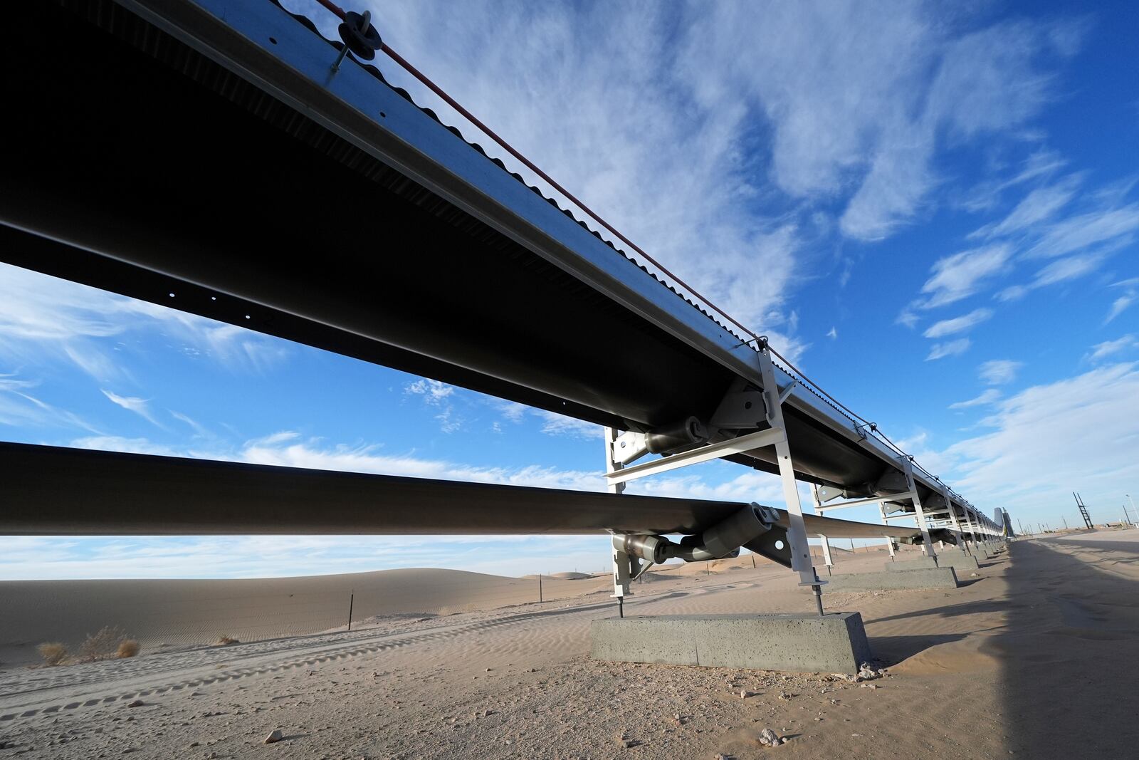 A 42-mile conveyor belt by Atlas Energy carries sand needed for hydraulic fracturing Wednesday, Feb. 26, 2025, in Kermit, Texas. (AP Photo/Julio Cortez)