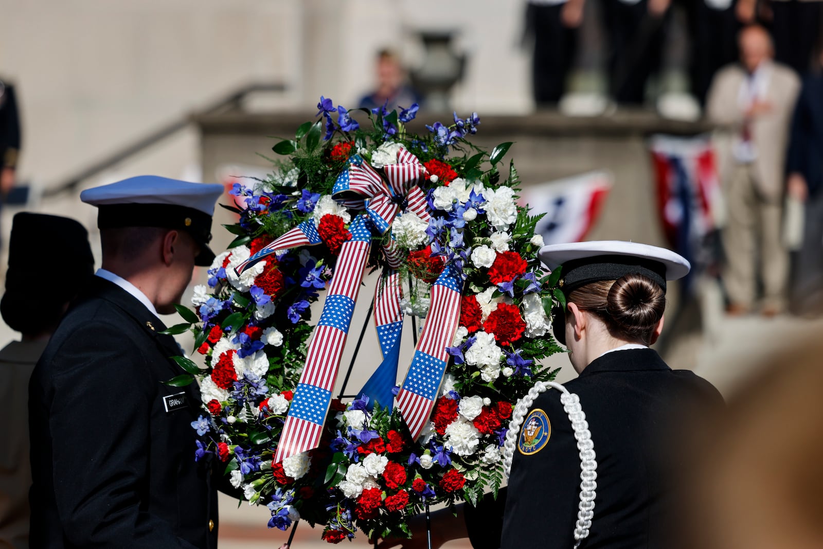 Members of Hamilton High School NJROTC place a wreath during a wreath laying ceremony in front of the Soldiers, Sailors and Pioneers Monument before the Memorial Day Parade Monday, May 29, 2023 in Hamilton. NICK GRAHAM/STAFF