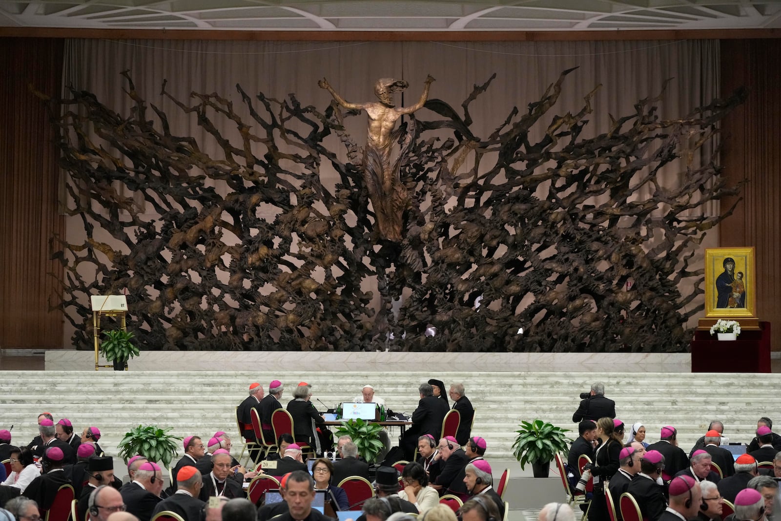 Pope Francis, background center, attends the works of the second session of the 16th General Assembly of the Synod of Bishops in the Paul VI hall, at the Vatican, Saturday, Oct. 26, 2024. (AP Photo/Gregorio Borgia)