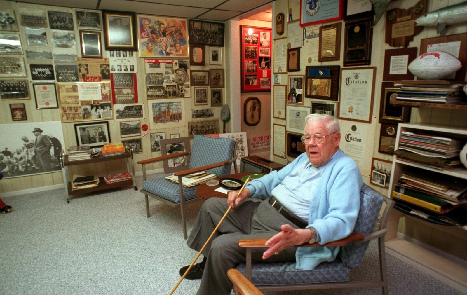 Weeb Ewbank, a member of Miami’s Athletic Hall of Fame Class, inducted in 1969, and former Super Bowl winning coach of the New York Jets. Ewbank is pictured in his basement surrounded by football memorabilia in this 1998 file photo. STAFF FILE/1998