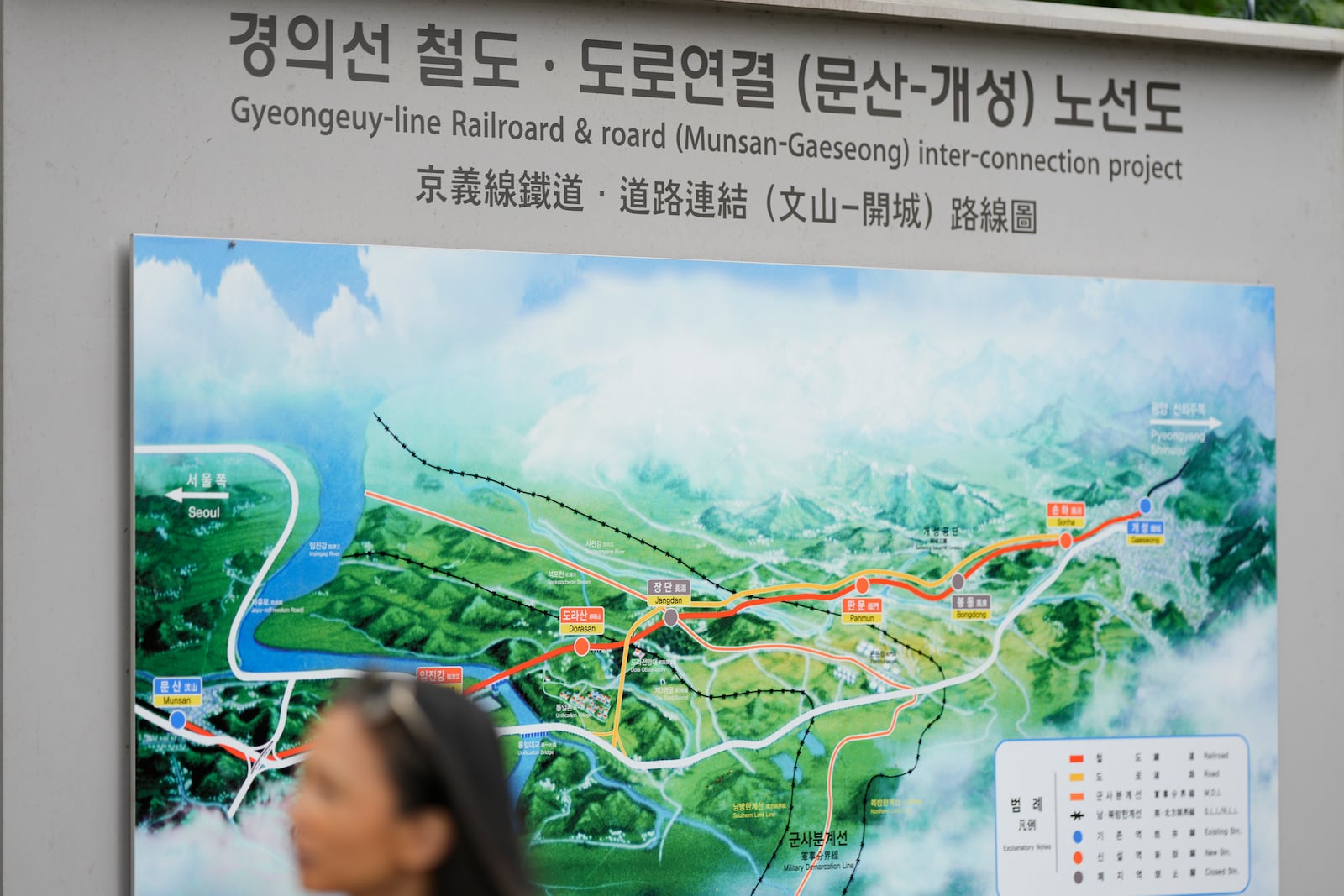 A visitor walks by a map of railroad and road between two Koreas cities, South's Munsan and North's Kaesong, at the Imjingak Pavilion in Paju, South Korea, Tuesday, Oct. 15, 2024. (AP Photo/Lee Jin-man)