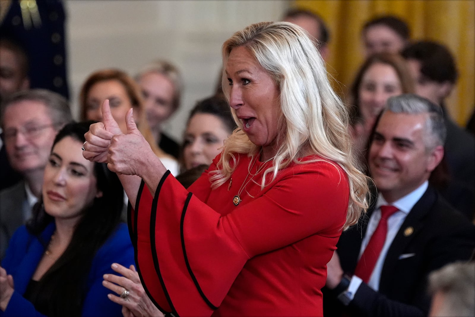 Rep. Marjorie Taylor Greene, R-Ga., gestures as President Donald Trump speaks before signing an executive order barring transgender female athletes from competing in women's or girls' sporting events, in the East Room of the White House, Wednesday, Feb. 5, 2025, in Washington. (AP Photo/Alex Brandon)