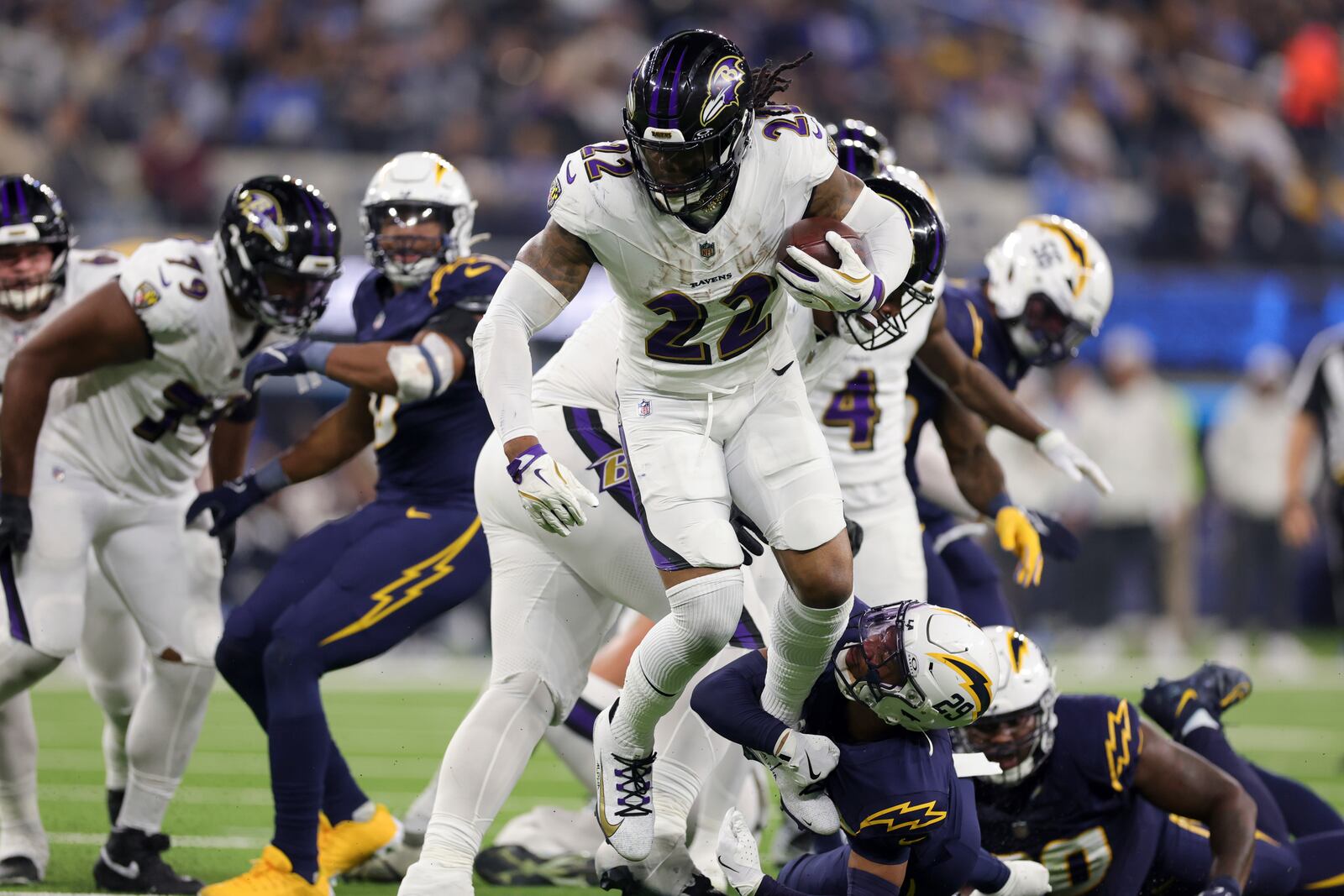 Baltimore Ravens running back Derrick Henry (22) is tackled by Los Angeles Chargers cornerback Tarheeb Still (29) during the second half of an NFL football game Monday, Nov. 25, 2024, in Inglewood, Calif. (AP Photo/Ryan Sun)