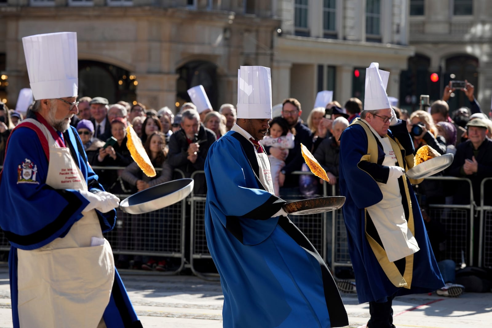 Runners compete during a traditional pancake race by livery companies at the Guildhall in London, Tuesday, March 4, 2025.(AP Photo/Frank Augstein)