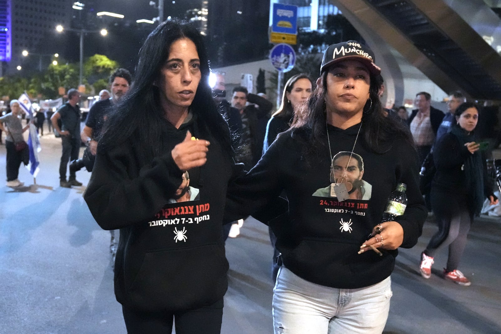 FILE - Einav Zangauker, left, mother of Israeli hostage Matan Zangauker, and his partner, Ilana Gritzewsky, protest in Tel Aviv, Israel, on Saturday, Dec. 7, 2024, in support of hostages held by Hamas in Gaza. (AP Photo/Mahmoud Illean, File)