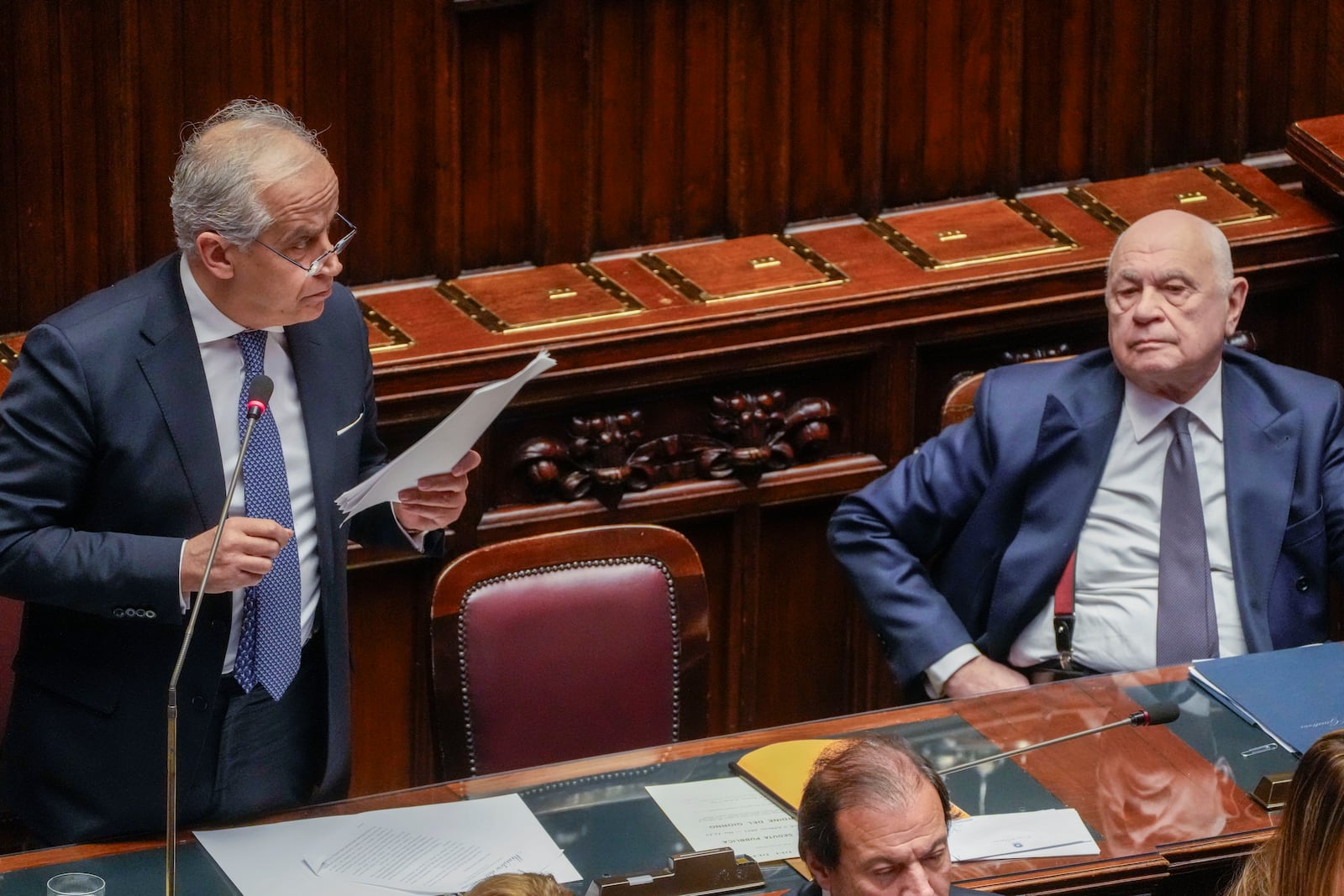 Italian Justice Minister Carlo Nordio, right, listens to Interior Minister Matteo Piantedosi during a debate in the Italian lower Chamber in Rome, Wednesday, Feb. 5, 2025, over the controversial repatriation, last week, of a Libyan warlord, Ossama Anjiem, also known as Ossama al-Masri, wanted by the International Criminal Court in the Hague, and who had been arrested in Turin, northern Italy. (AP Photo/Gregorio Borgia)