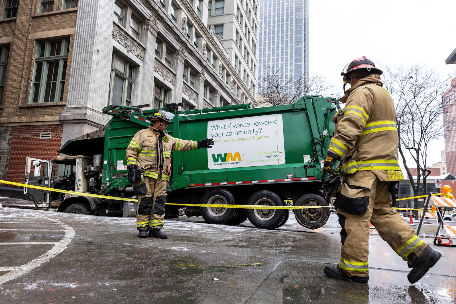 The Omaha Fire Department is on the scene where a garbage truck got stuck in a sinkhole in downtown Omaha, Neb., Thursday, Jan. 2, 2025. (Chris Machian/Omaha World-Herald via AP)