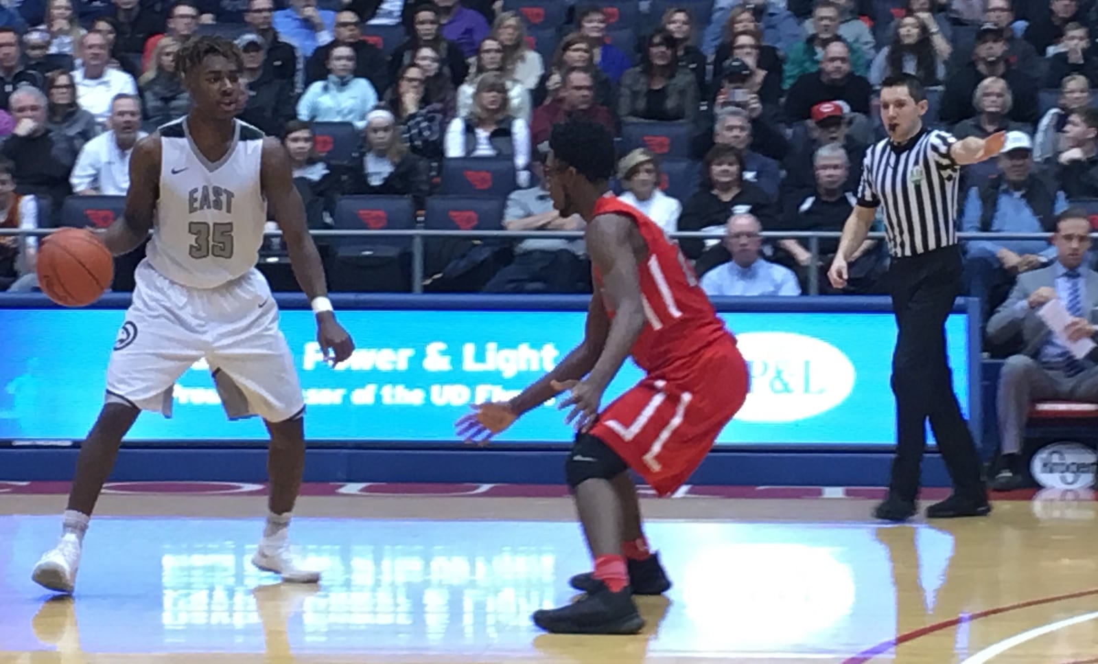 Lakota East’s Jarrett Cox is under the watchful eye of Princeton’s Aaron Ward during Saturday afternoon’s Division I district final at the University of Dayton Arena. RICK CASSANO/STAFF