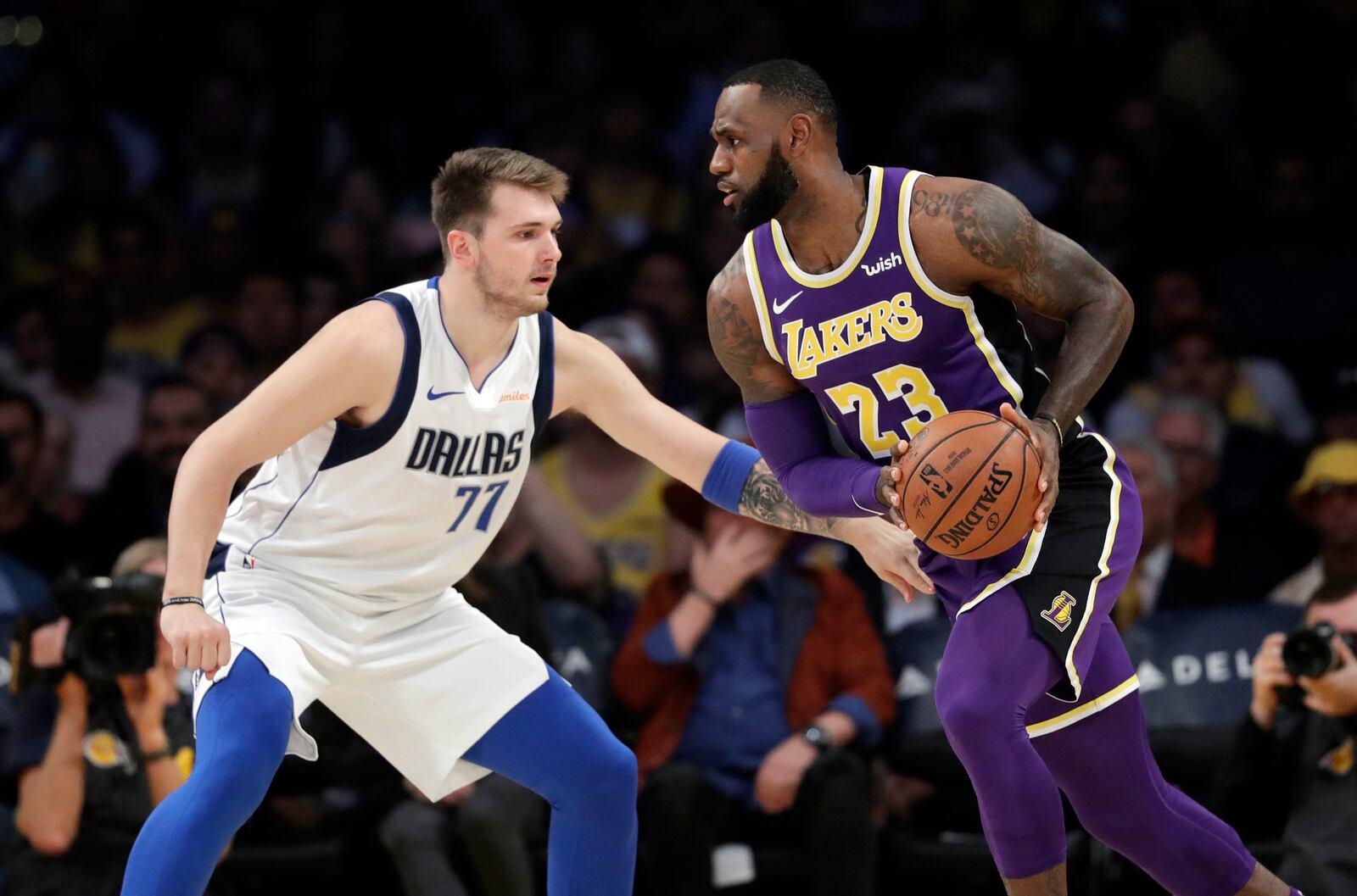 FILE - Los Angeles Lakers' LeBron James (23) is defended by Dallas Mavericks' Luka Doncic (77) during the first half of an NBA basketball game, Oct. 31, 2018, in Los Angeles. (AP Photo/Marcio Jose Sanchez, File)