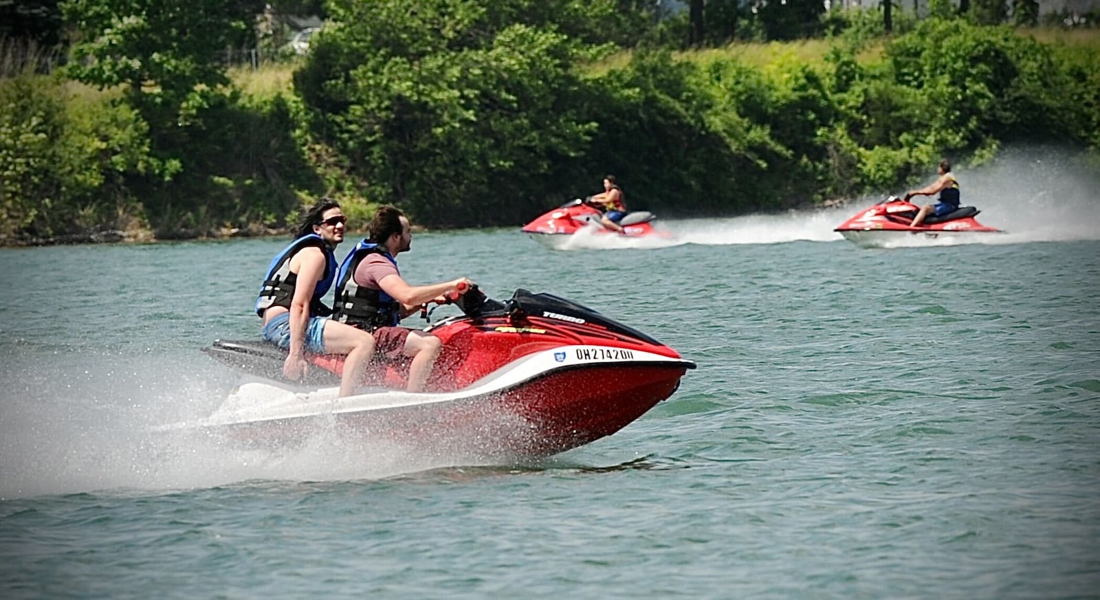 People enjoy themselves Tuesday on jet skies at Eastwood Lake near Dayton. Rescue crews are pleading with people to wear their life jackets when on lakes or rivers.