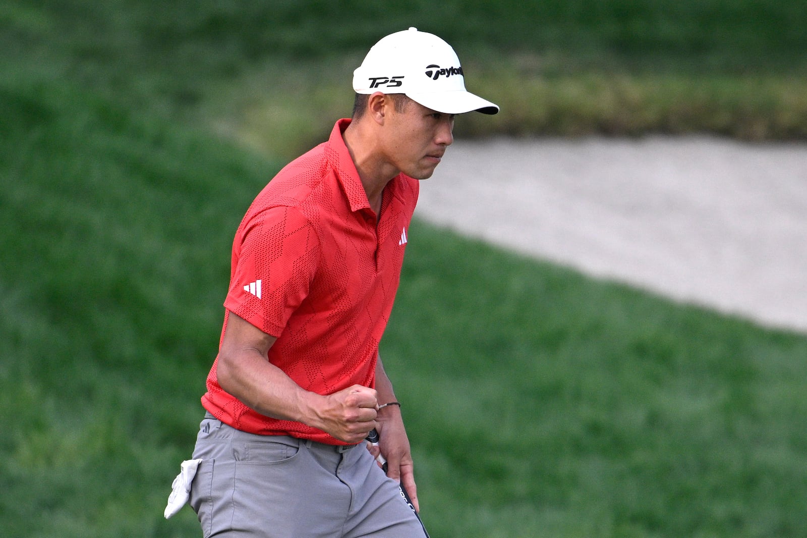 Collin Morikawa pumps his fist after making a putt for birdie and the lead on the 18th green during the third round of the Arnold Palmer Invitational at Bay Hill golf tournament, Saturday, March 8, 2025, in Orlando, Fla. (AP Photo/Phelan M. Ebenhack)