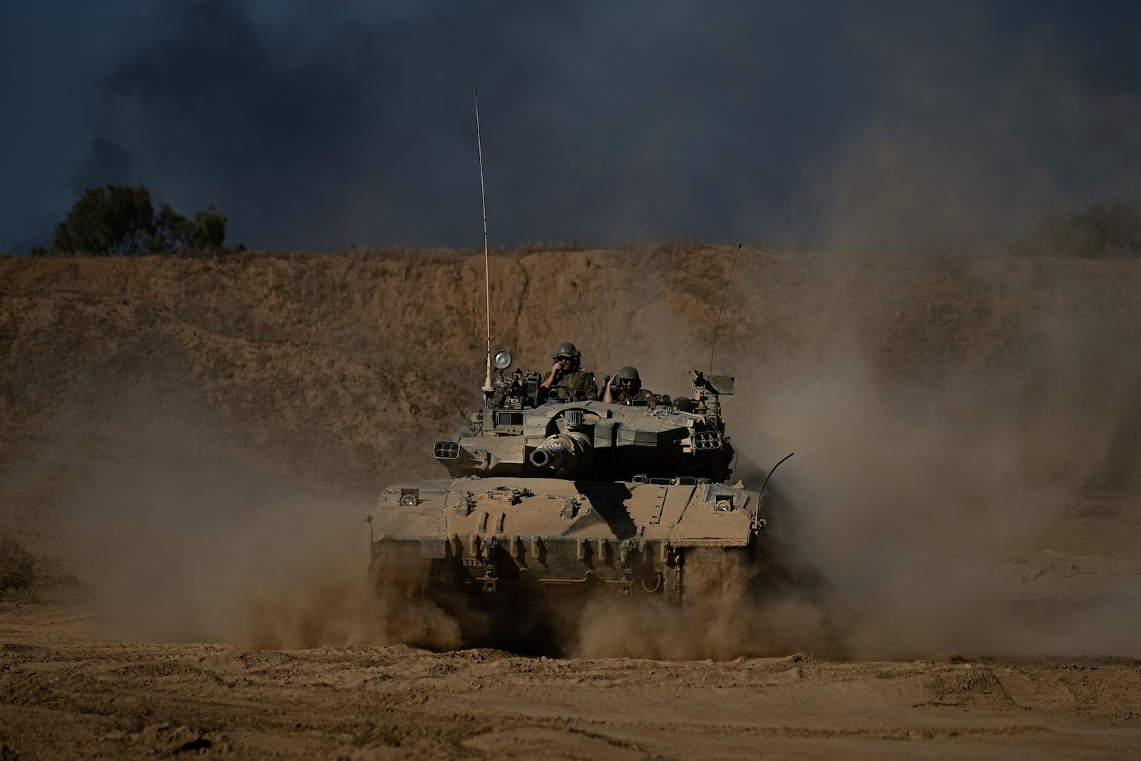 An Israeli army tank maneuvers near the Israel-Gaza border in southern Israel, Sunday, Oct. 20, 2024. (AP Photo/Tsafrir Abayov)