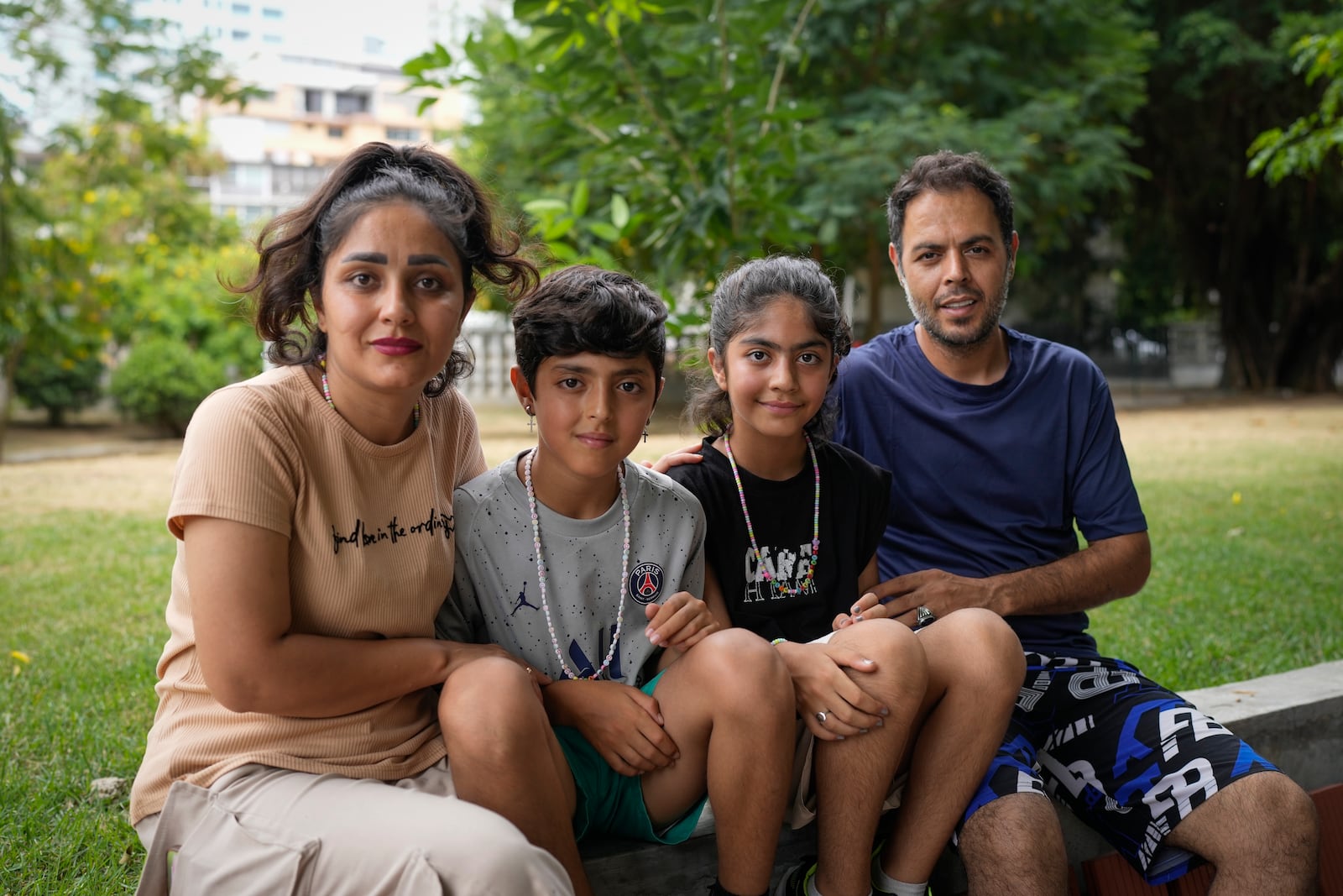 Ebrahim Ghezelgechi, right, a migrant from Iran, poses for a portrait with his wife Sahar Bideman and their children Sam and Aylin in Panama City, Monday, March 10, 2025, after they were deported from the U.S., detained for weeks in a Panamanian immigration camp, and released on a temporary humanitarian visa allowing a 30‑day stay. (AP Photo/Matias Delacroix)