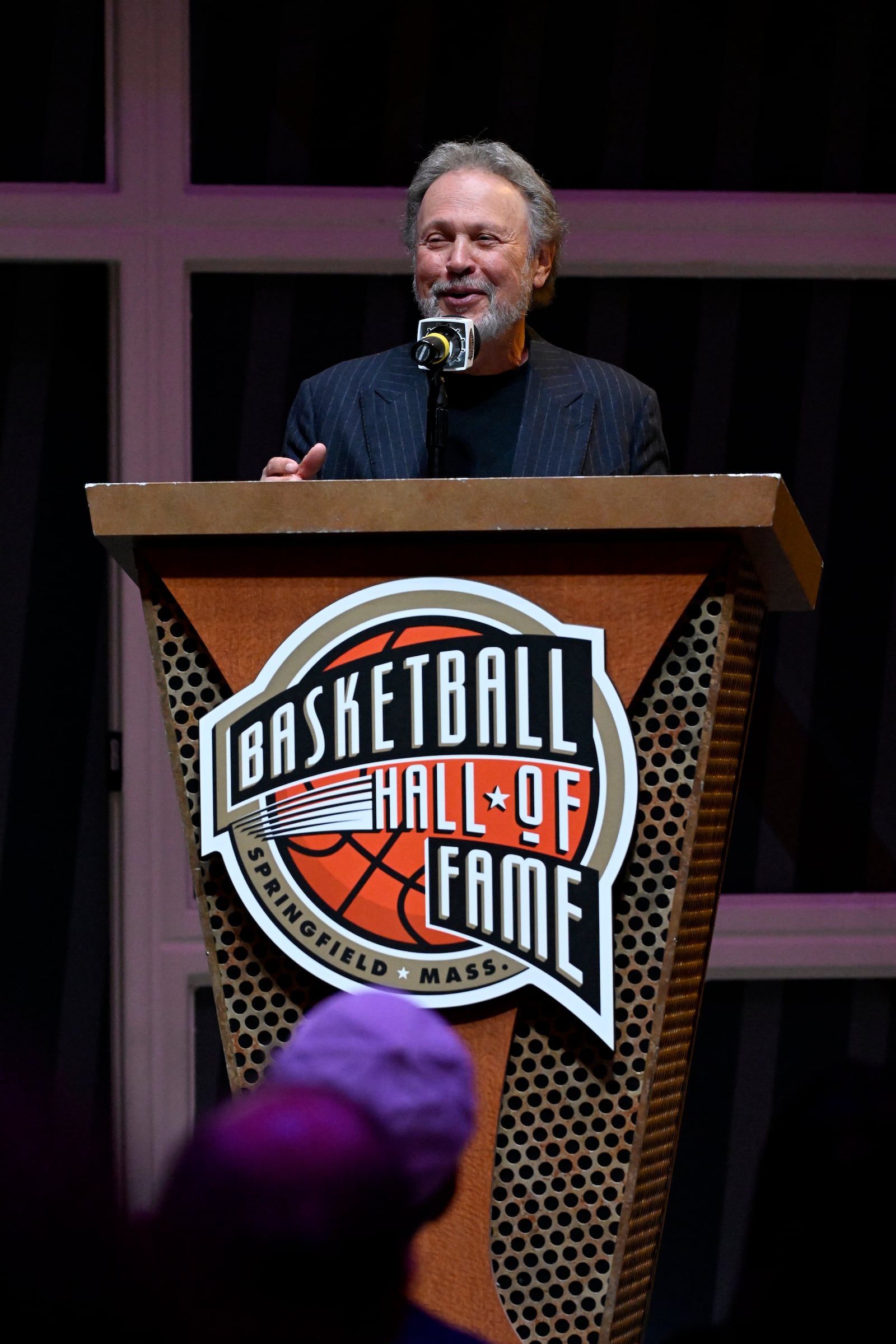 Comedian Billy Crystal speaks during a ceremony at the Basketball Hall of Fame, Sunday, Oct. 13, 2024, in Springfield, Mass. Crystal, actor Jack Nicholson, film director Spike Lee and businessman Alan Horwitz are being added to the Naismith Memorial Basketball Hall of Fame's James F. Goldstein SuperFan Gallery. (AP Photo/Jessica Hill)