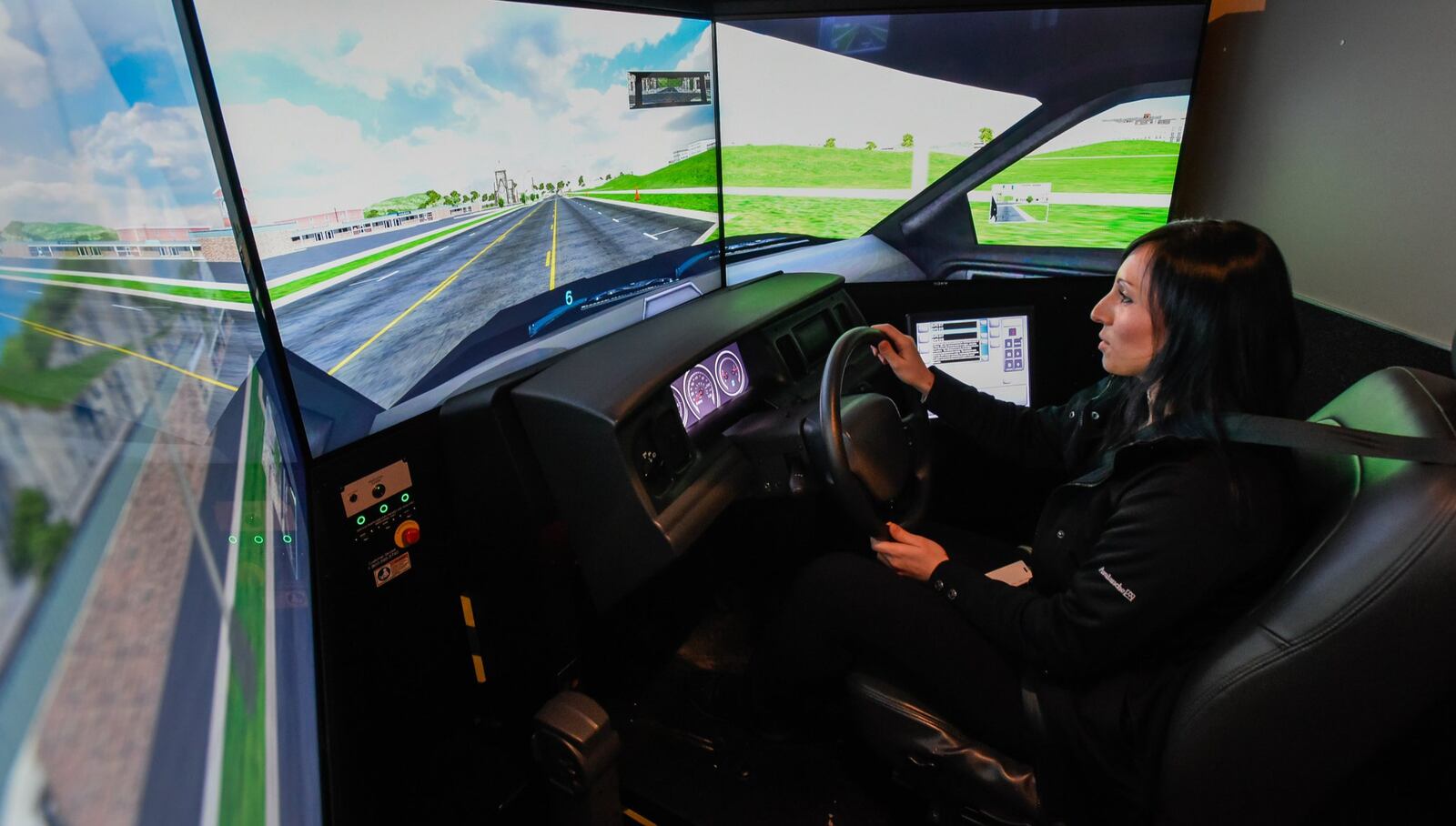 Middletown Division of Police Detective Beth Stewart sits in the seat of a driving simulator during a training session. NICK GRAHAM/STAFF