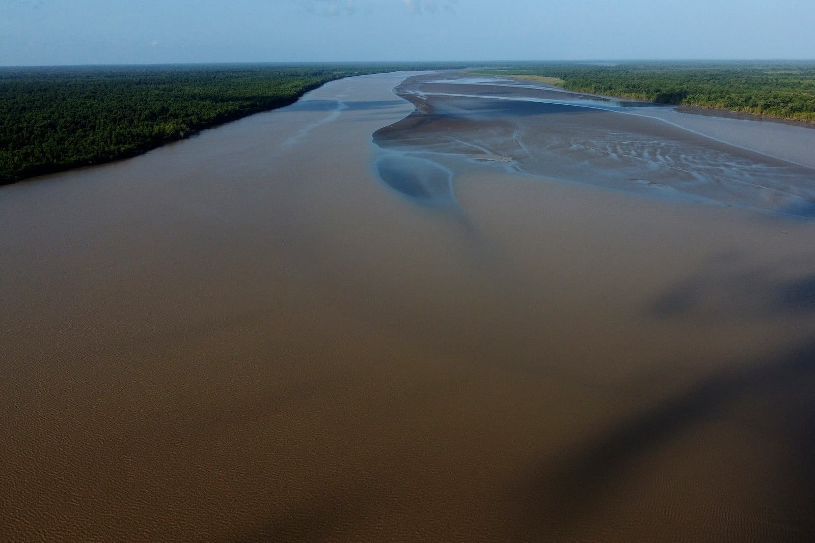 FILE - Water flows in at the point where the river meets the sea in the Bailique Archipelago, district of Macapa, state of Amapa, northern Brazil, Sept. 12, 2022. (AP Photo/Eraldo Peres, File)