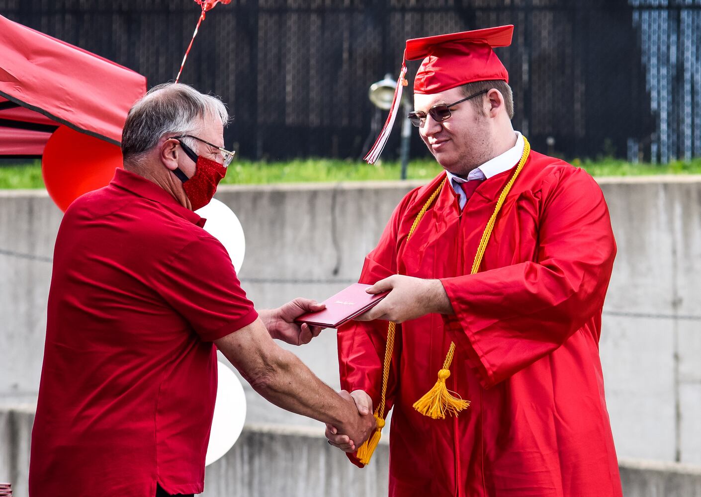 Madison High School drive-thru graduation ceremony at Land of Illusion