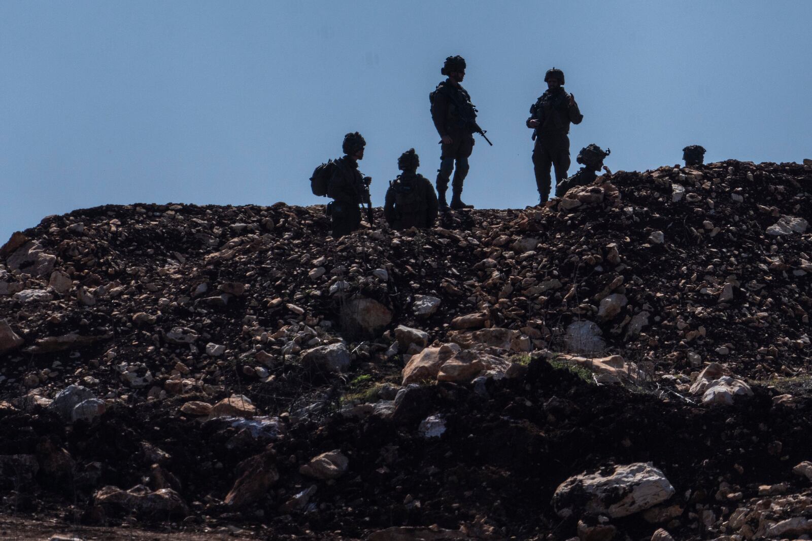 Israeli forces in a buffer zone after Israeli forces withdrew from border villages in southern Lebanon as seen from northern Israel, Tuesday, Feb. 18, 2025. (AP Photo/Ariel Schalit)