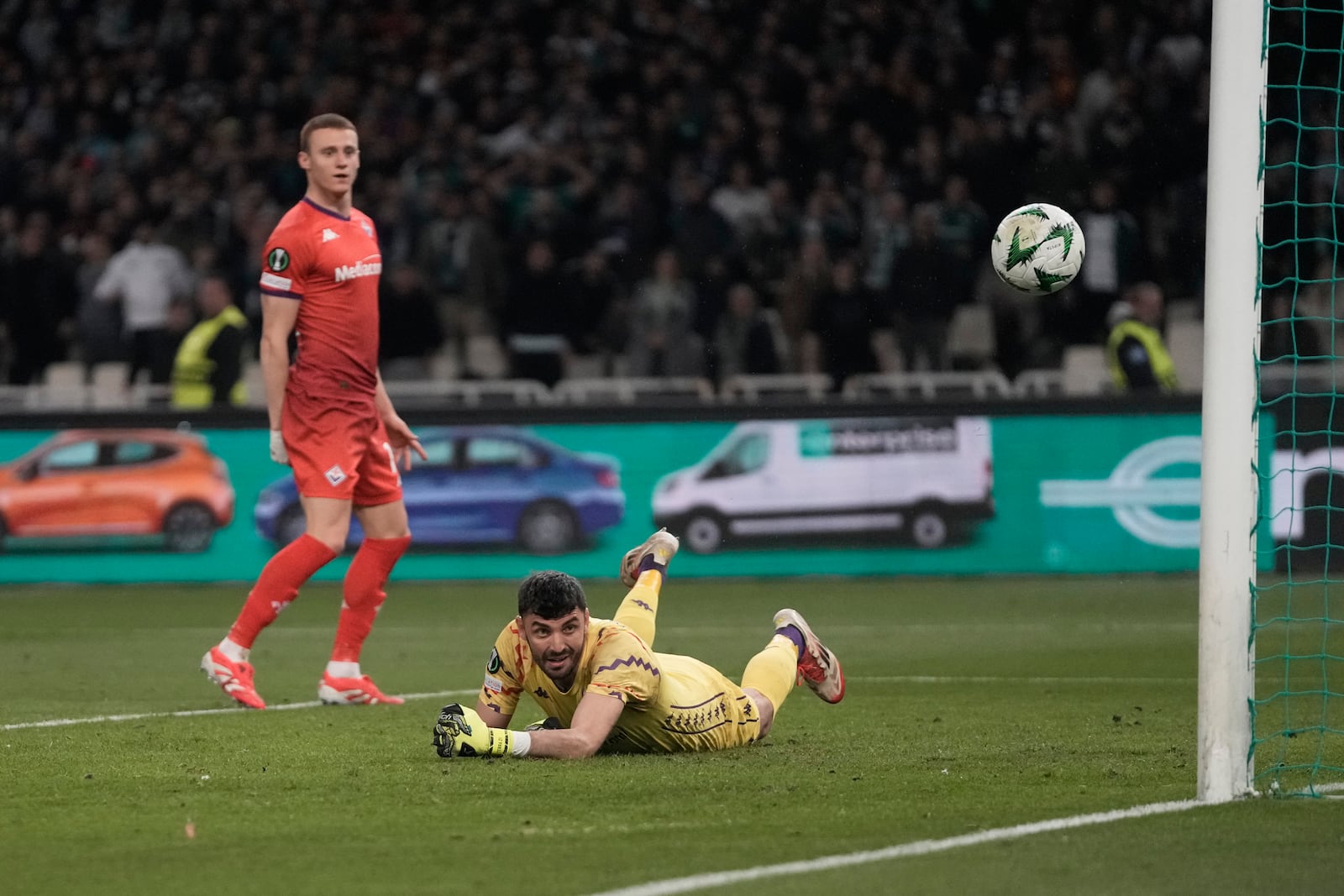 Fiorentina's goalkeeper Pietro Terracciano looks on as the ball hits the bar during the Europa Conference League round of 16 first leg soccer match between Panathinaikos and Fiorentina at the Olympic stadium in Athens, Greece, Thursday, March 6, 2025. (AP Photo/Thanassis Stavrakis)